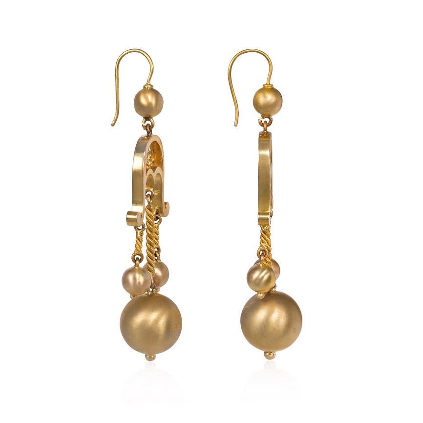 A pair of antique Victorian period gold earrings of girandole design comprised of three ball pendants suspended from a scrolled openwork surmount, in 14k.