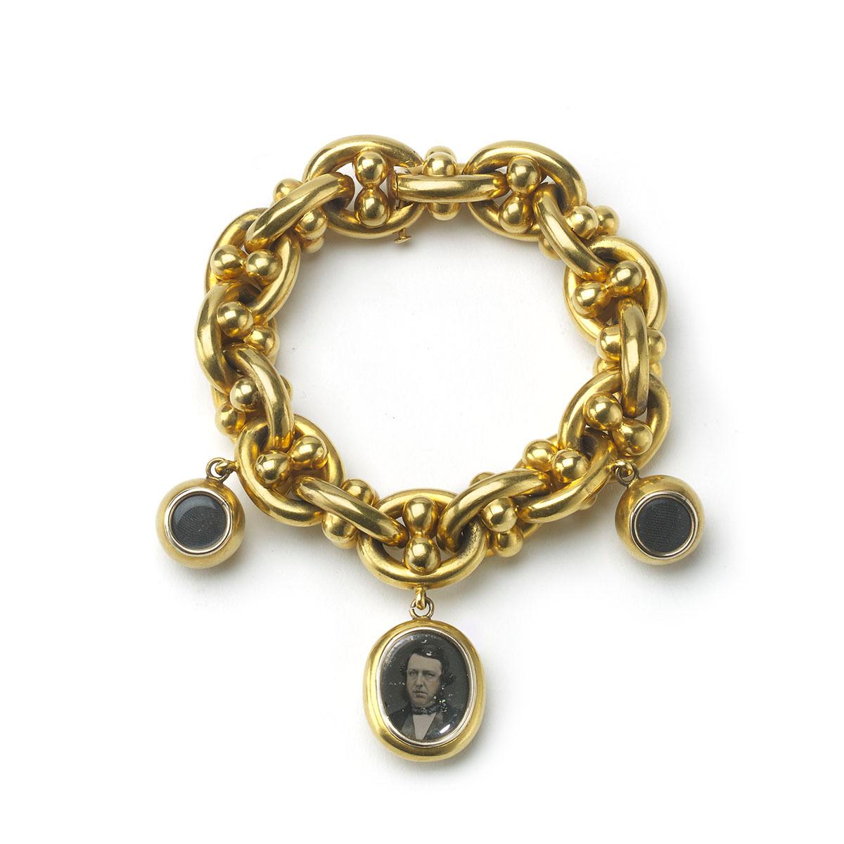 A Victorian, fancy oval link nautical gold bracelet, with an oval locket charm, containing a tinted collodion positive or ambrotype glass photograph of a gentlemen in Victorian dress, the reverse bearing an embossed anchor with entwined rope, with
