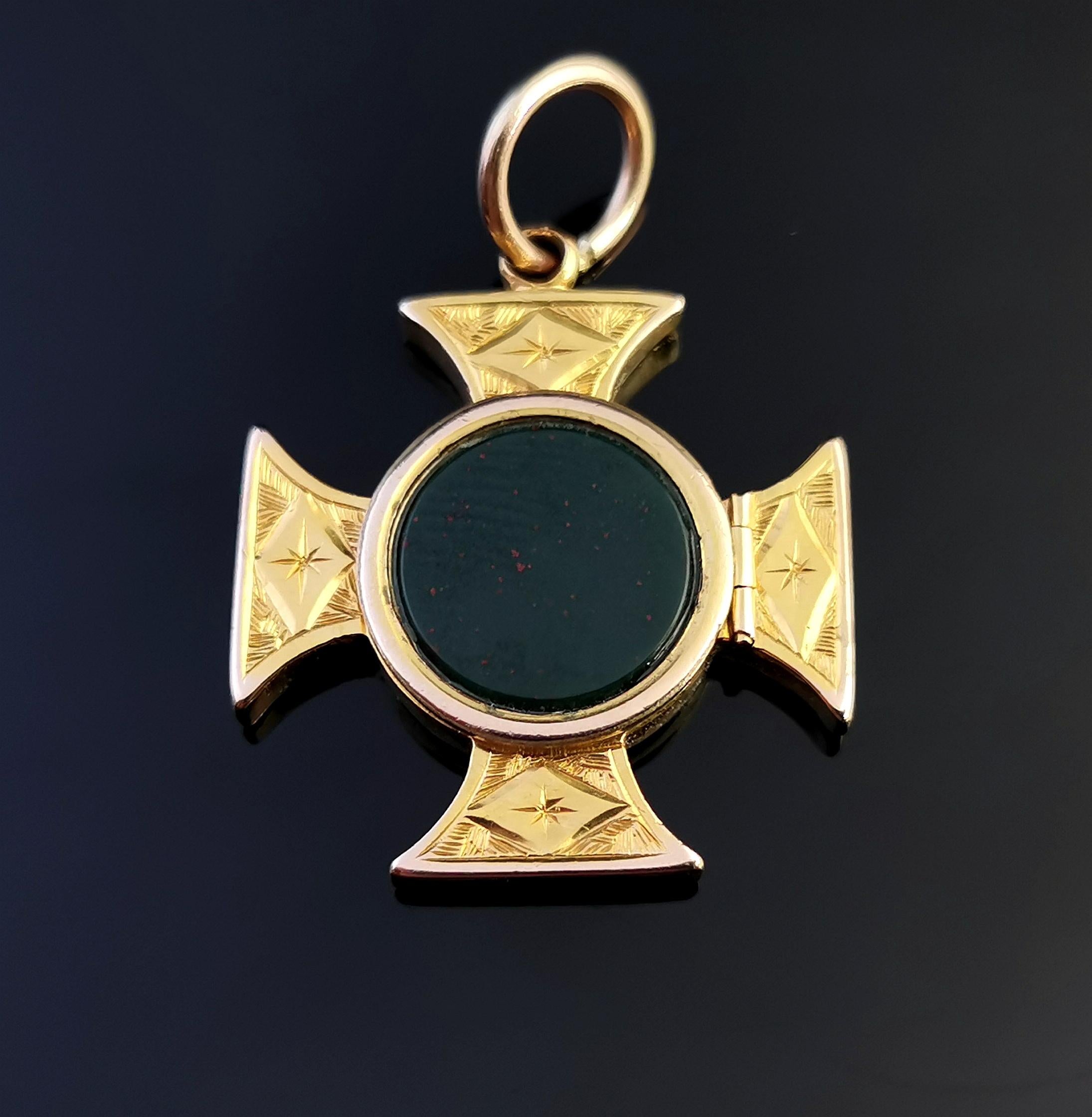 A stunning antique, Victorian era 9kt yellow gold Maltese Cross locket or poison locket.

This attractive pendant is designed as a Maltese Cross with a chased and engraved design of leaves and flora.

The front features a bloodstone slab with a
