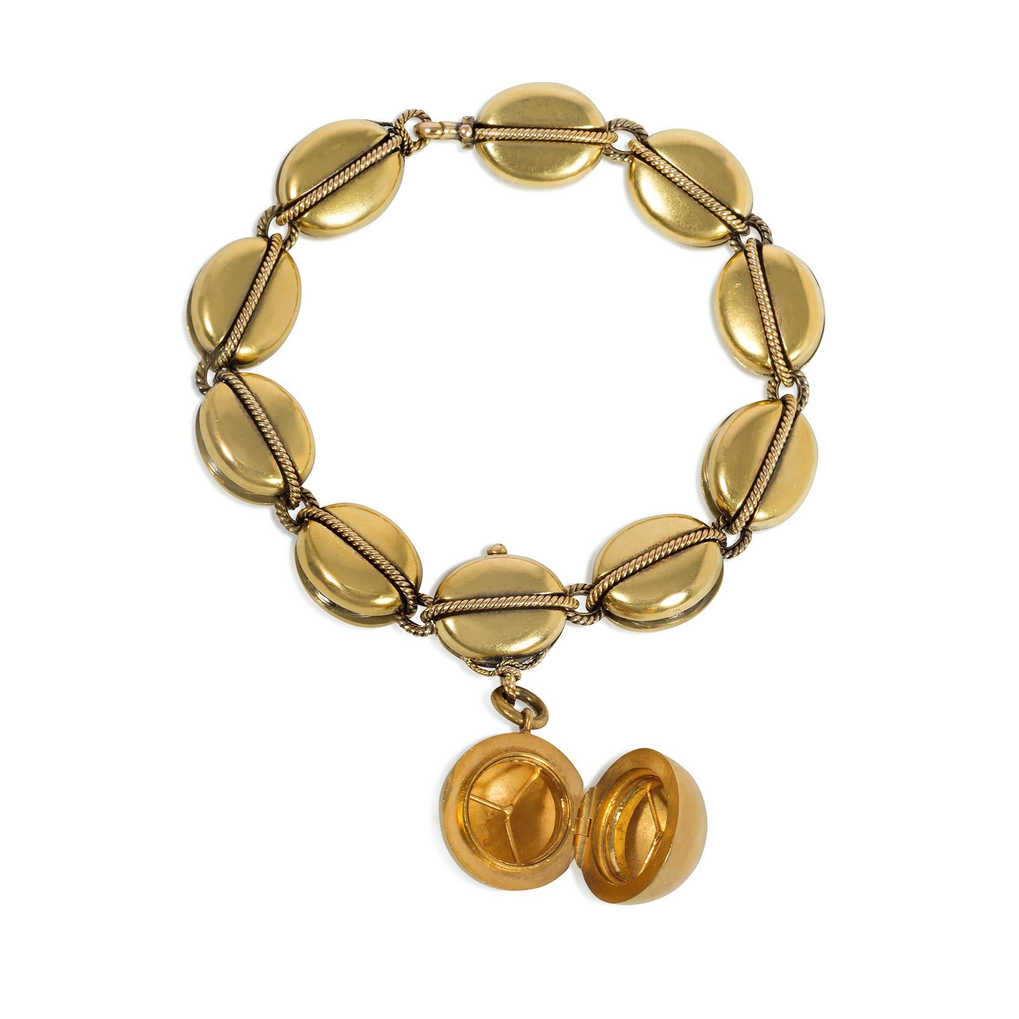 A Victorian gold bracelet designed as nautical pulley links and culminating in a ball pendant charm with a concealed locket, in 15k. Hunt and Roskell, England

Dimensions: 6.75