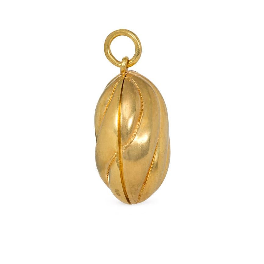 An antique gold oval locket pendant with double-sided curved fluted design and two interior picture compartments, in 15k.  England.  (Chain not included.)  Approximately 1 1/4