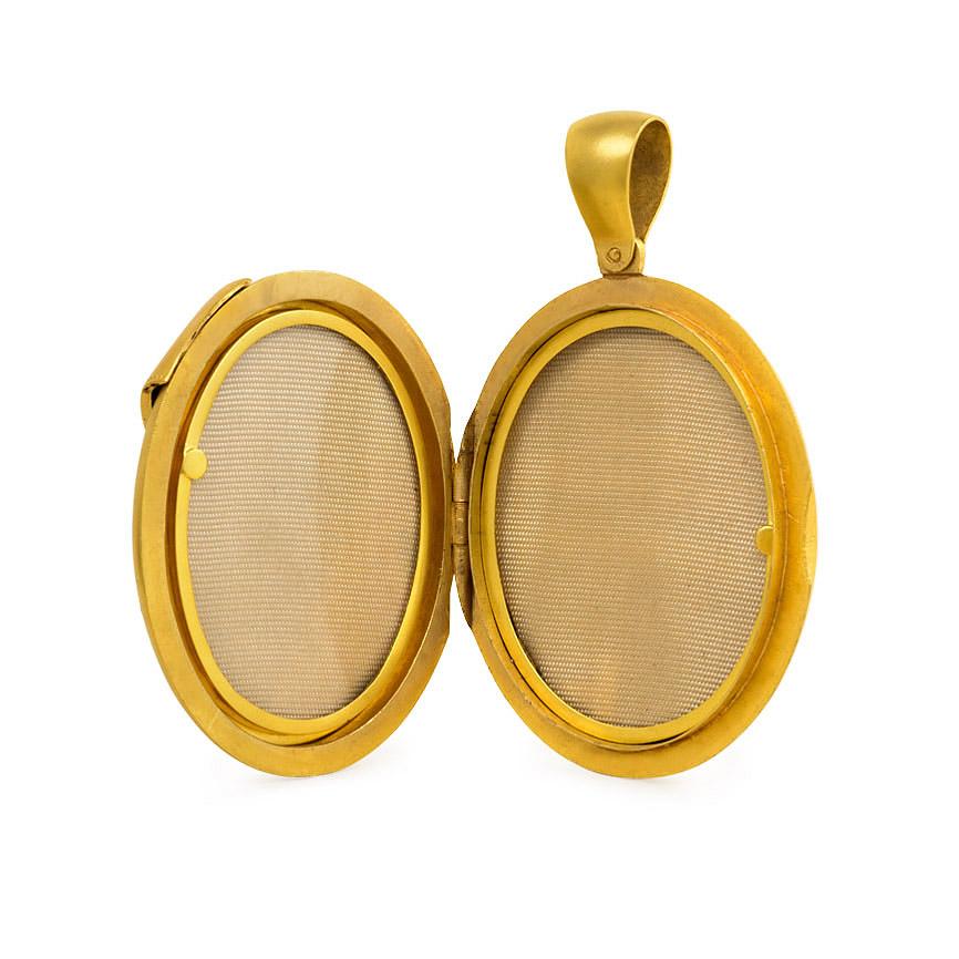 An antique oval gold locket pendant with diamond-accented belt buckle motif and two interior compartments, in 15k.  England.  (Chain not included.)
Dimensions: 2 3/8