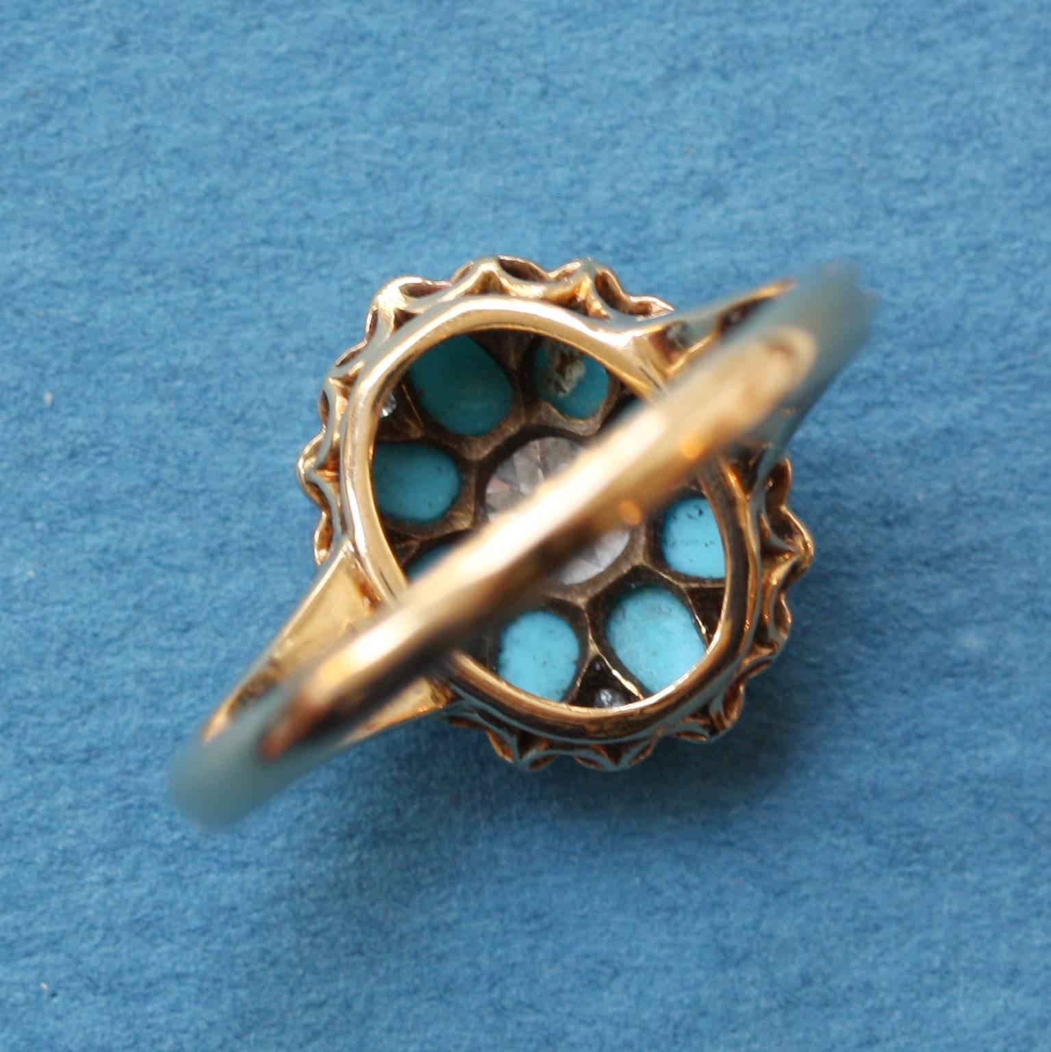 An 18 carat gold ring with a flower of eight drop shaped cabochon cut turquoises in between which are rose cut diamonds and in the heart a cushion cut diamond, all open set, circa 1890, England.

weight: 3.2 grams
ring size: 16.5 mm