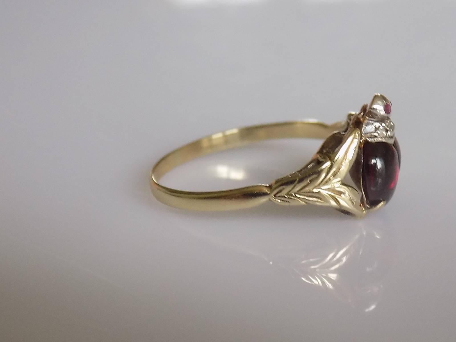 A Lovely Victorian Garnet and Rose cut Diamond Ladybird ring. Stones in Silver topped gold setting. A very unique and rare ring. English origin.

Size R UK, 9 US can be sized.
Height of the face 10mm.
Weight 3.0gr.
Unmarked.

Overall very good