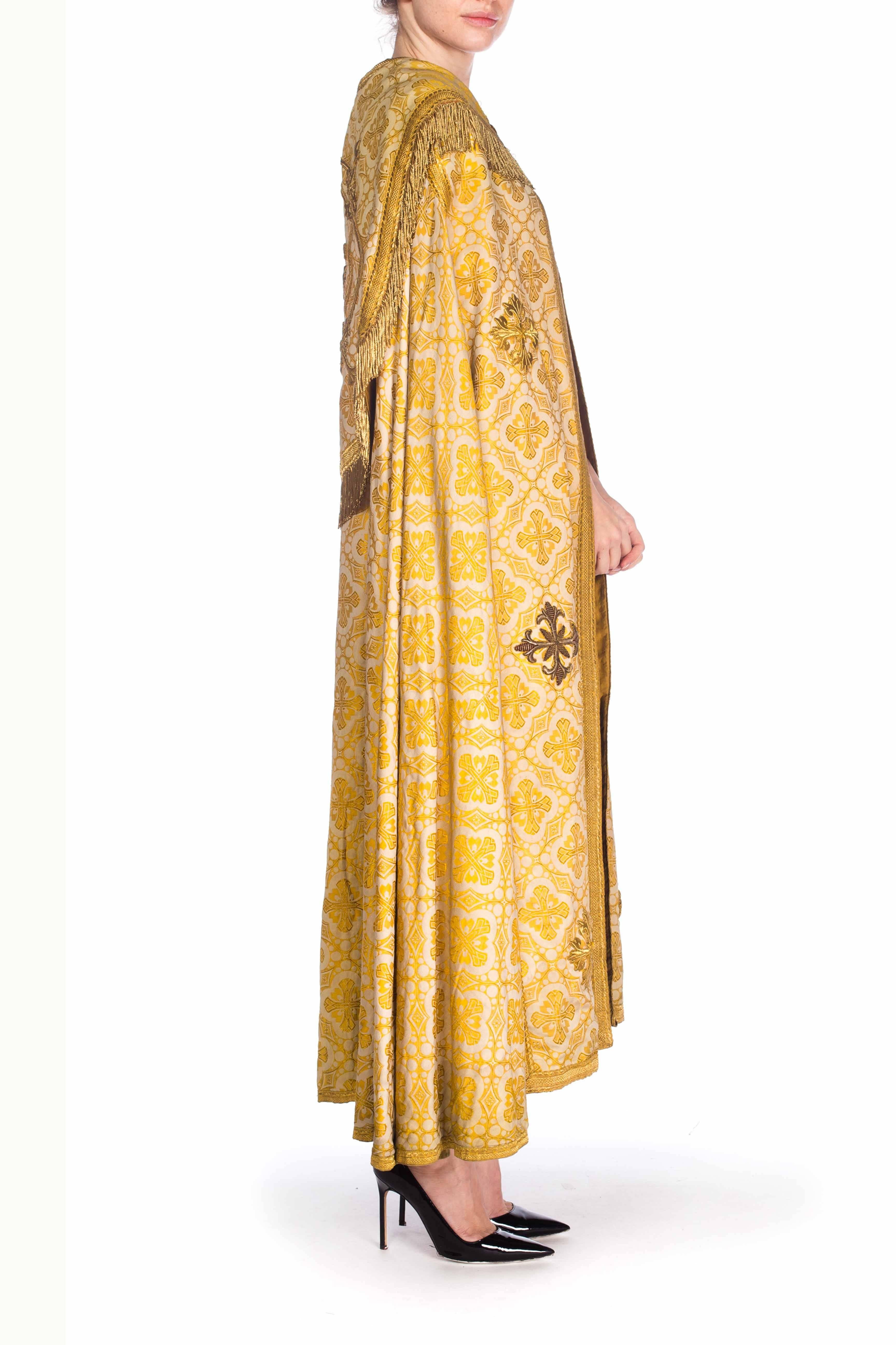 From France, fully lined in gold cotton sateen. Victorian Gold Silk & Cotton Brocade Long Catholic Cape With Real Fringe Embroidery 

Has marks in the inner lining on the bottom. 