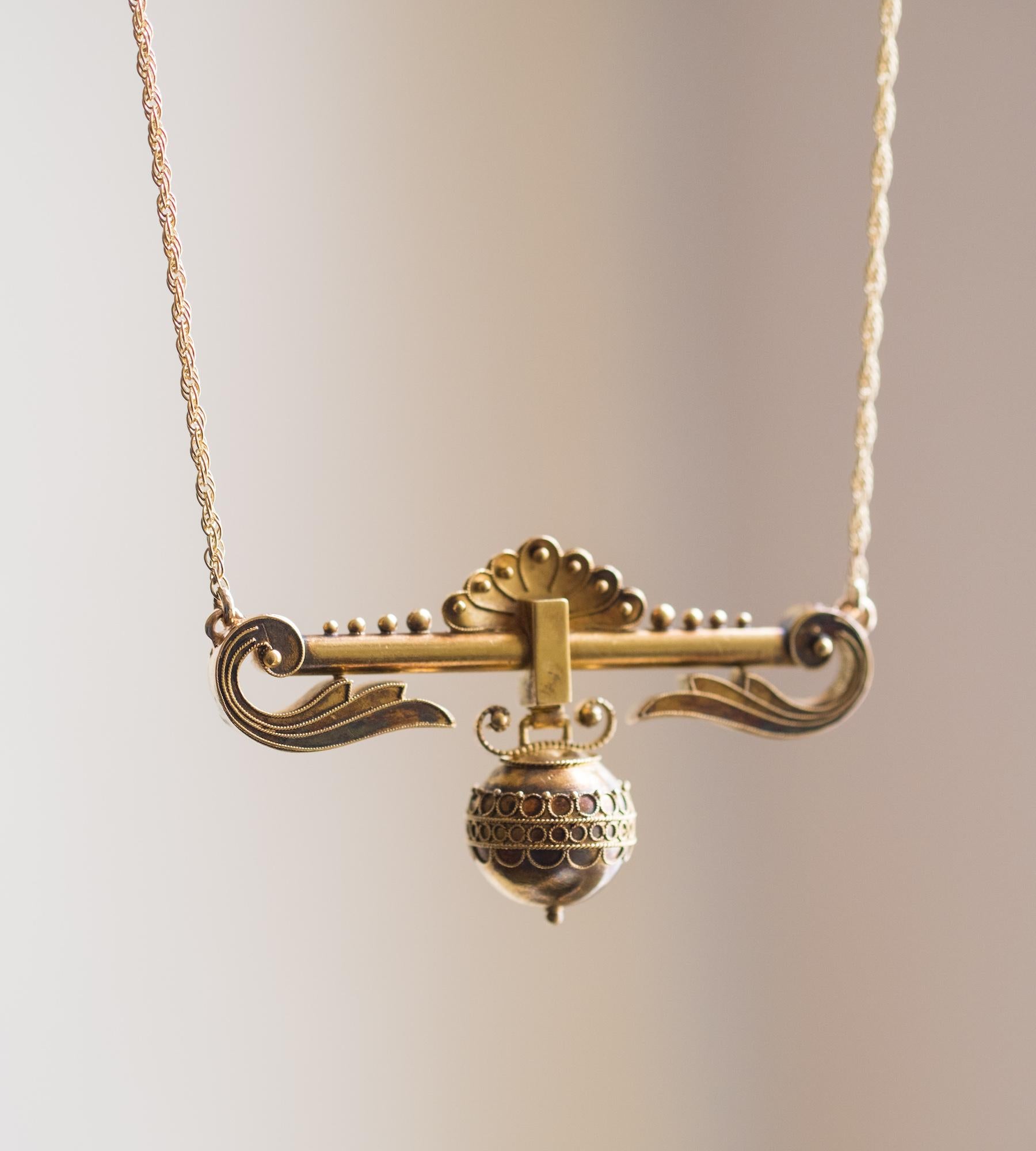 Our latest Fleur Fairfax transformation piece is a highly decorative gold necklace; a former brooch from the late 19th C. Re-imagined here on fixed gold chain, the design features a unique hanging sphere with ornamental filigree decoration. Gold