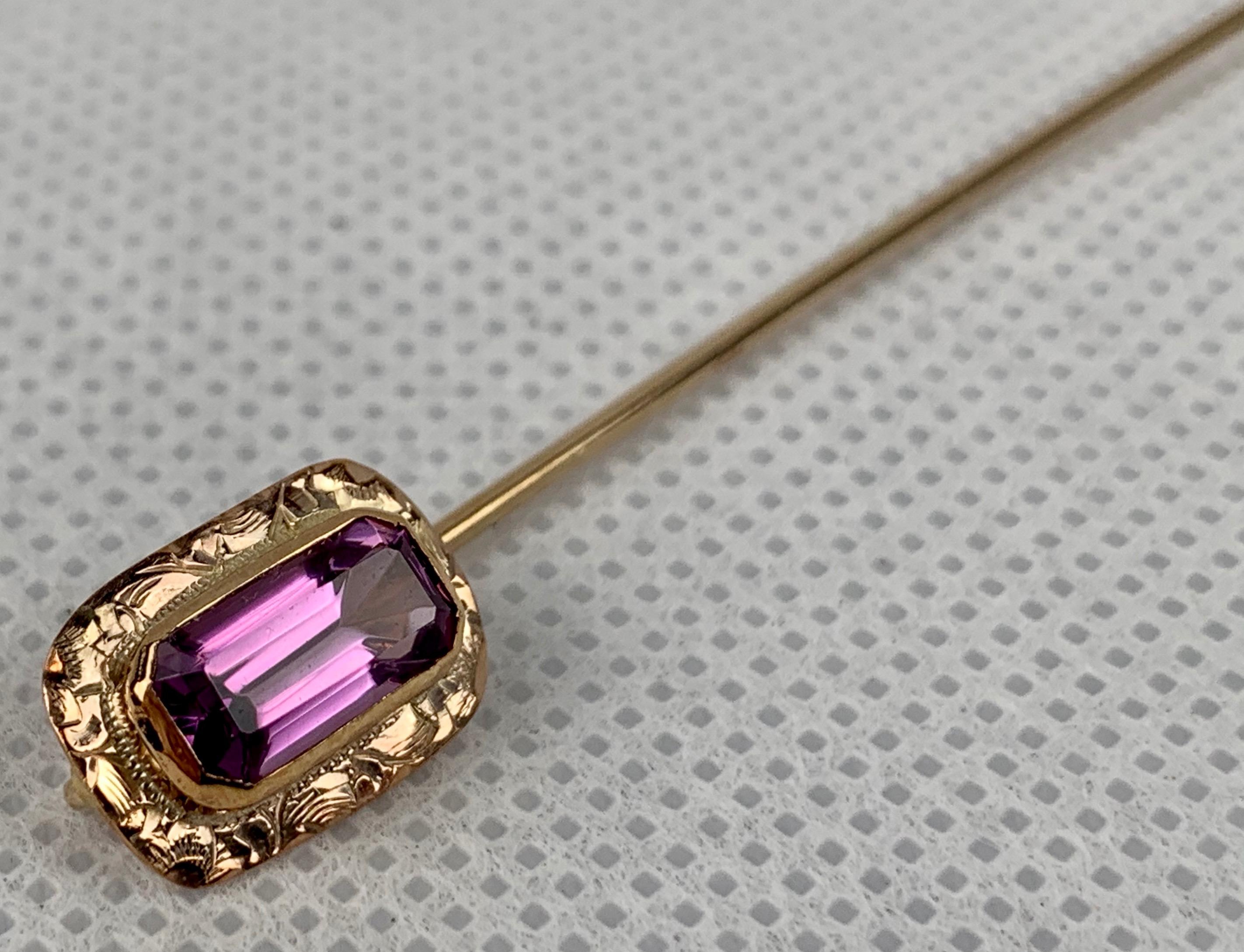 A Victorian 10k yellow gold gentleman's antique stickpin set with a faceted, rectangular cut amethyst stone.  The gold frame is beautifully hand engraved.
Professionally cleaned and polished.
1.8 grams
L-2.5