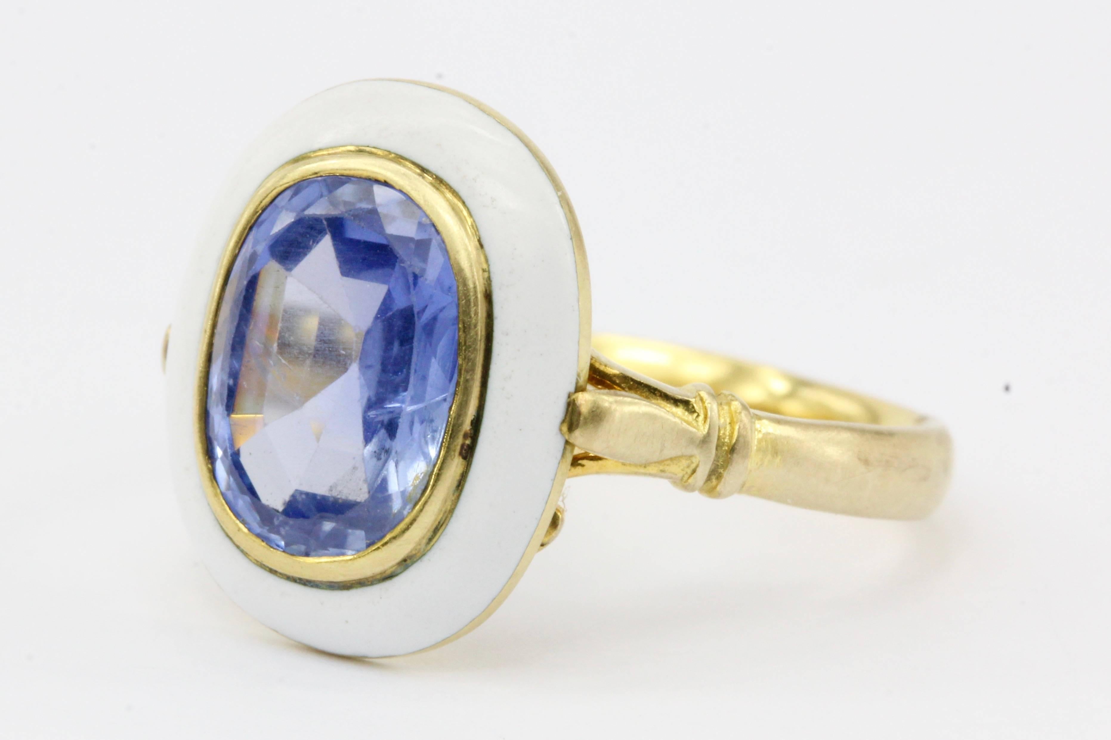 Era: Late Victorian

Composition: 10k Yellow Gold w/ White Enamel

Primary Stone: Natural untreated Blue Burma Sapphire

Stone Carat: Approximately 2.1 carat 

Dimensions: 9.58 x 7.09. 3.84mm

Color / Clarity: Violetish Blue / Transparent

Shape: