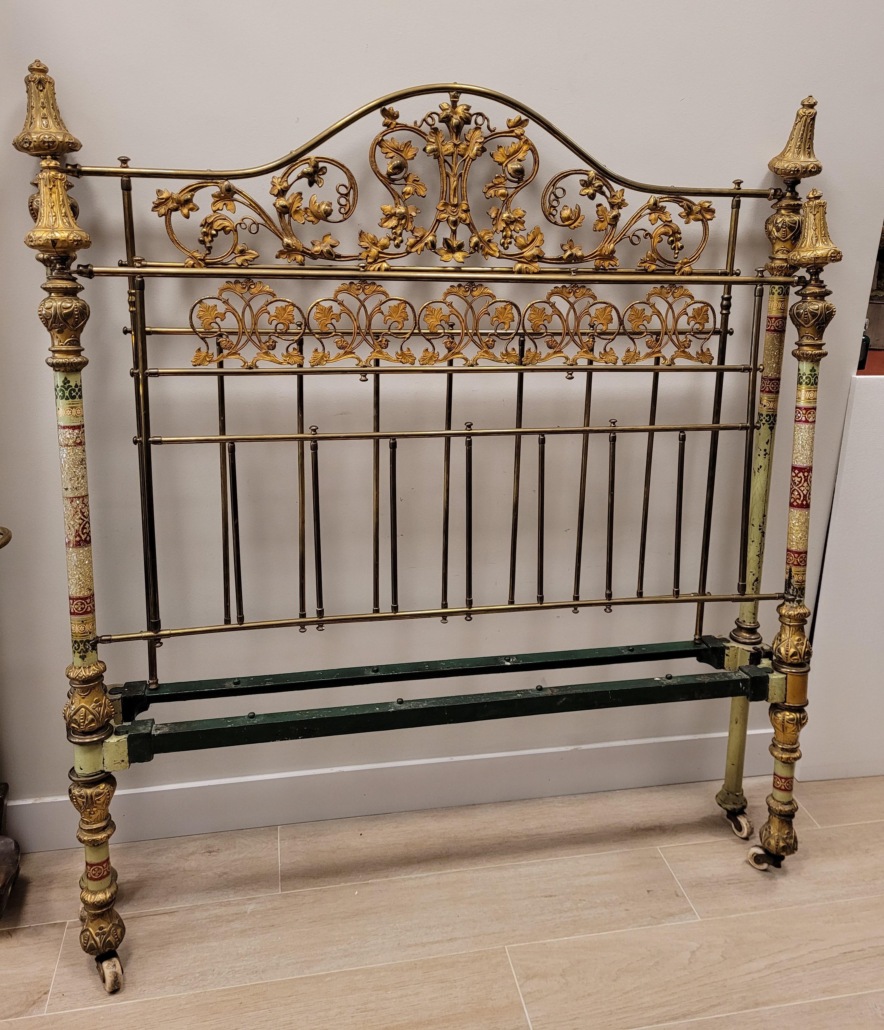 One of kind victorian bed in golden bronze. Headboard and feet with filigrees in golden bronze. Side bars in the four main corners with end knobs (in the lower, central, and high parts) finely decorated. 
Bars decorated with oriental motifs painted