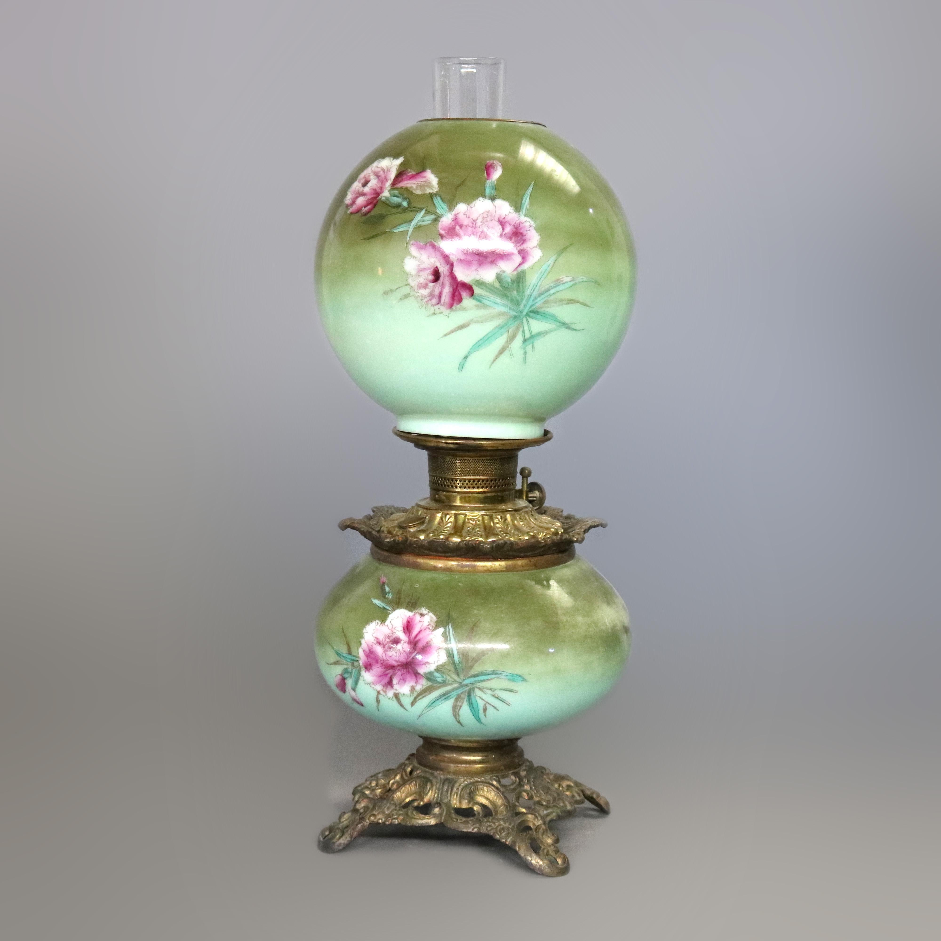 An antique Victorian Gone with the wind oil table lamp offers floral hand-painted glass globe and font on foliate cast base, fully operating and non-converted oil lamp, c1890

Measures - 21.75'' H x 8.25'' W x 8.25'' D.