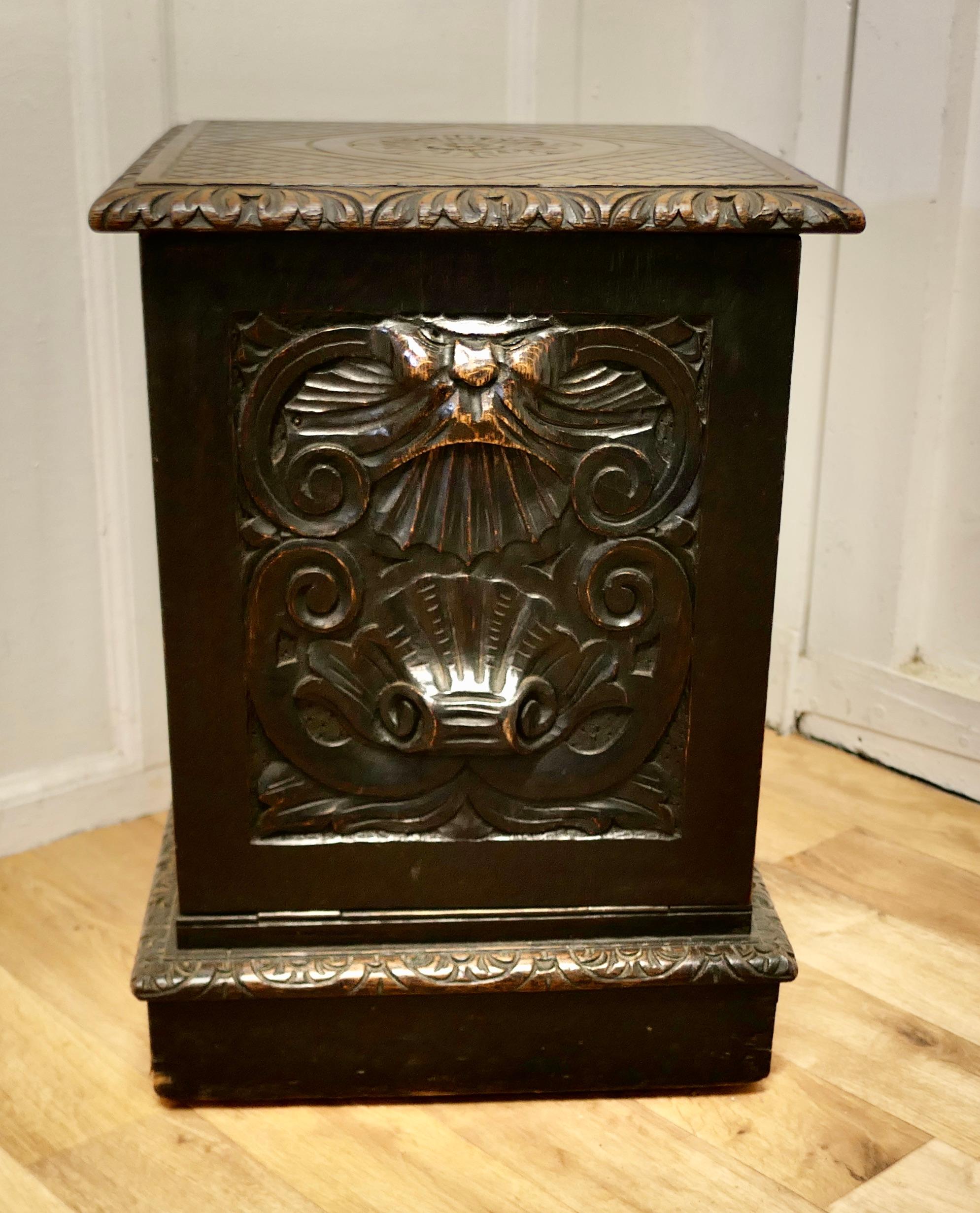 Victorian Gothic carved oak green man coal or log box

This is an unusual design, the Purdonium is carved in the Gothic Oak Style, with a geometric panel on the top and the handle on the fall front is carved with the face of the Green Man with a