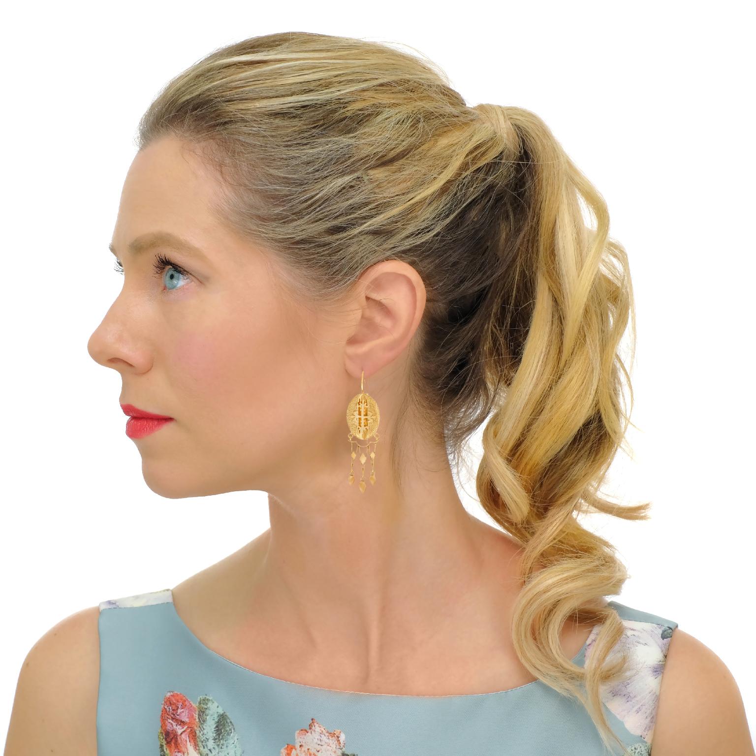 Circa 1870s, 14k.   These fabulous antique chandelier earrings are stylish, playful, and elegant. Their fine detail, contrasting textures, and articulated construction offer an exciting visual narrative. Completing the story, the gothic crosses with
