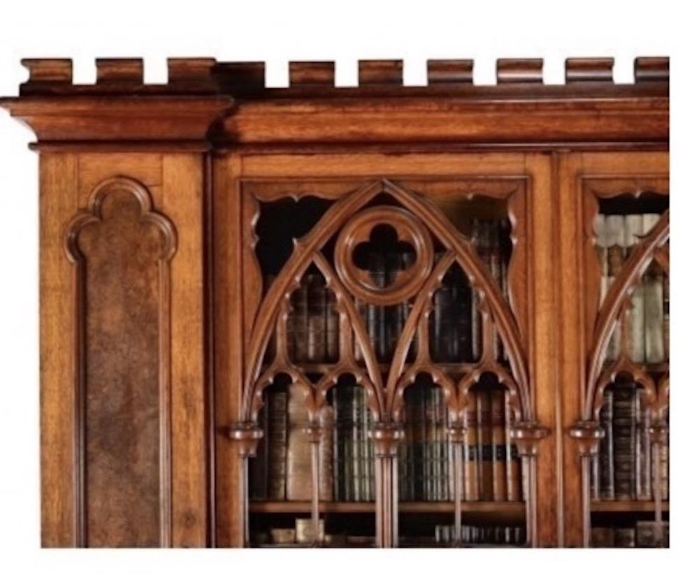 Stunning and magnificent example of a Gothic Revival pollard oak cabinet bookcase, circa 1880, this is an amazing piece and would grace any of the countries cathedrals or stately homes.

This exceptional bookcase is of inverted breakfront outline,