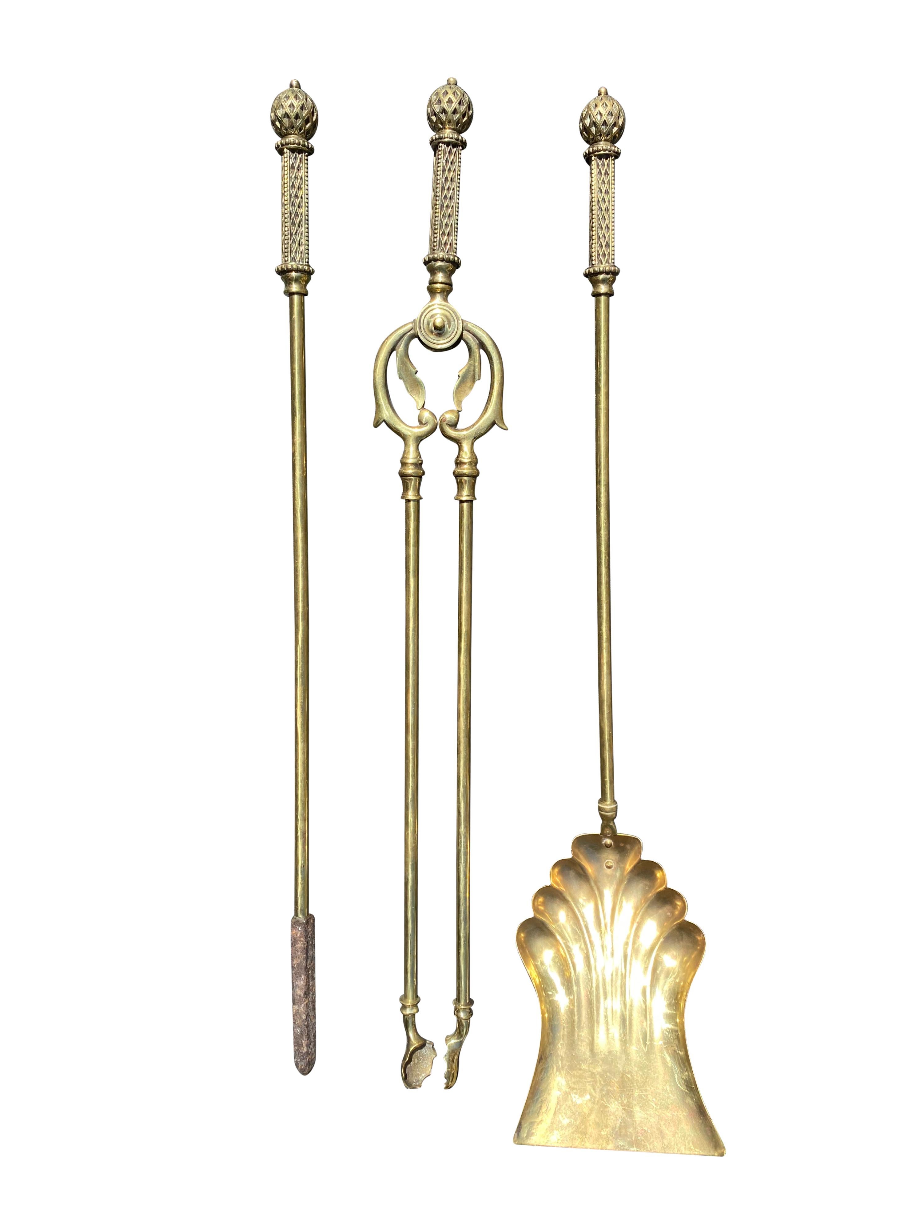A stunning antique Victorian Gothic brass fire companion set. The superb set is solid brass, with beautifully handcrafted matching motifs. This is truly a remarkable set, with fantastic craftsmanship and rare design. A brilliant example of the