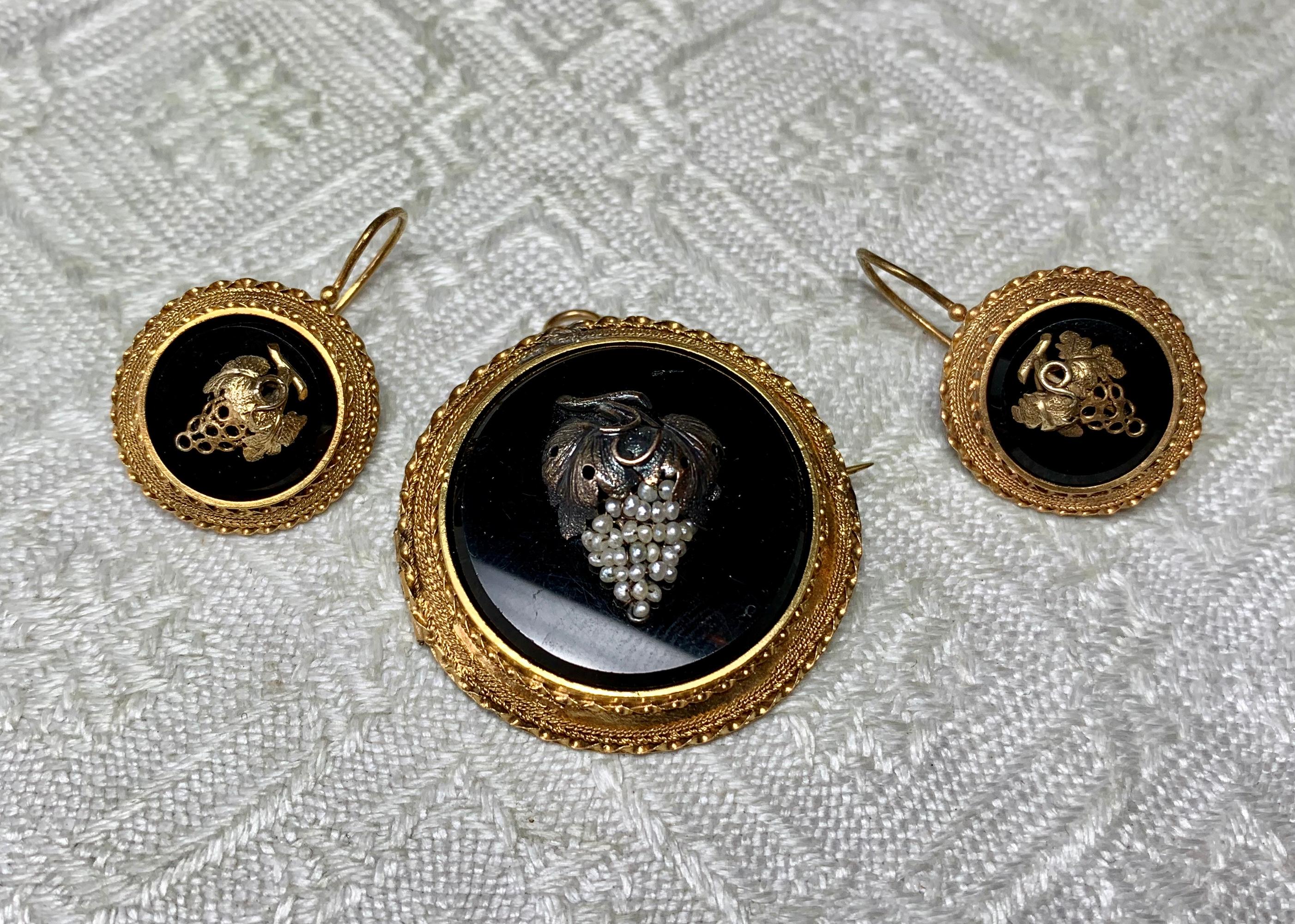 A SUITE OF GRAPE MOTIF VICTORIAN ETRUSCAN REVIVAL EARRINGS WITH THE MATCHING PENDANT/BROOCH.  THE JEWELS ARE SET WITH STUNNING GRAPE CLUSTERS IN THE CENTER, MOUNTED ON BLACK ONYX.  THE GOLD WORK IS GORGEOUS 14-16K GOLD IN A BRAIDED ETRUSCAN MOTIF. 