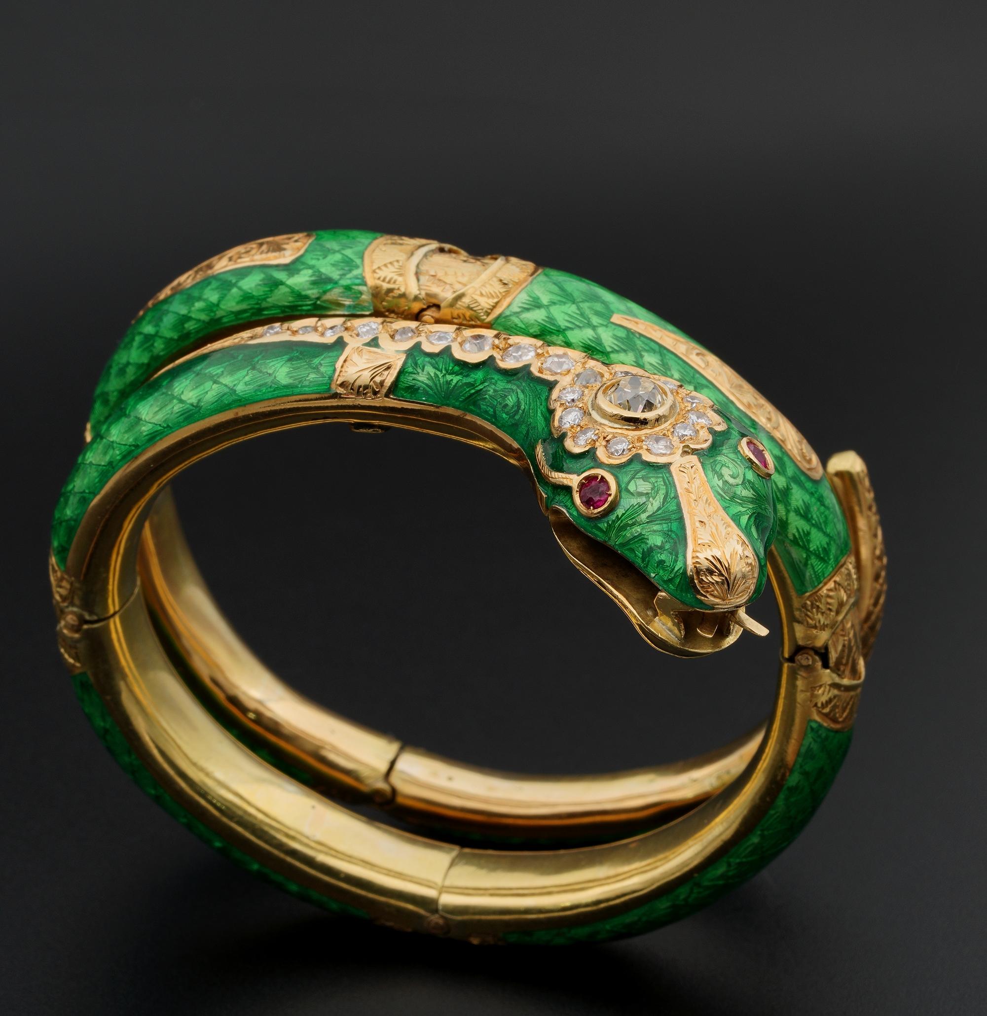 This marvelous Snake bangle is Victorian period 1890 ca
Impressive in design wrapping twice around the wrist with a large head and spectacular guilloche enamel work of rich luxurious Green color with gold carved inserts for effect
Head is enhanced