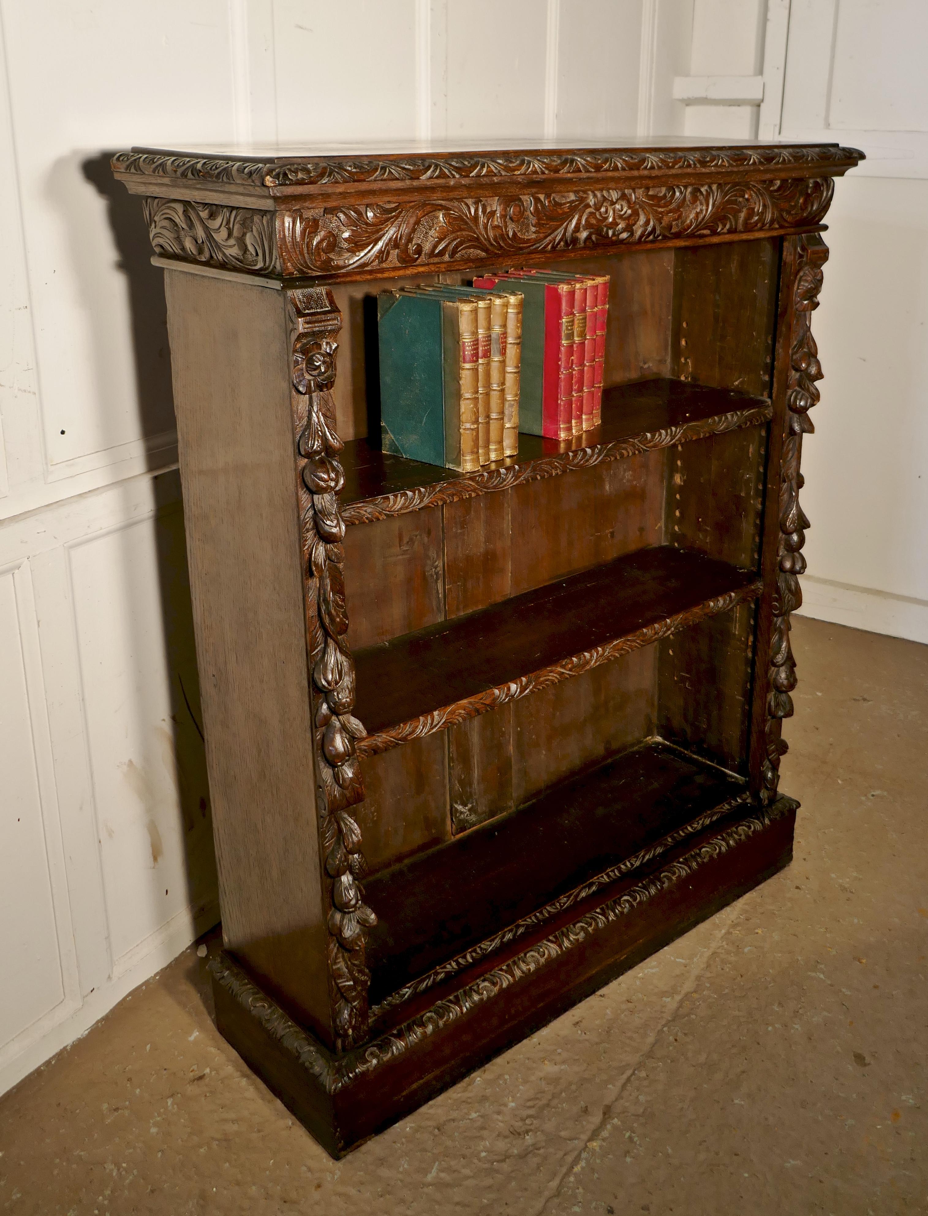 Victorian green man Gothic open bookcase.

The bookcase is the very finest of quality, the carving is very crisp, the bookcase has 2 adjustable shelves, these have a carved border to the front.
The side columns are beautifully carved there are