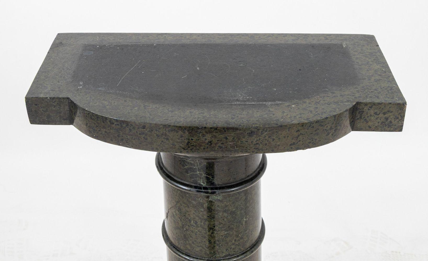 Victorian Green Serpentine Pedestal, late 19th century, the rounded rectangular revolving top above a tapering column, on a stepped circular plinth. 42.75