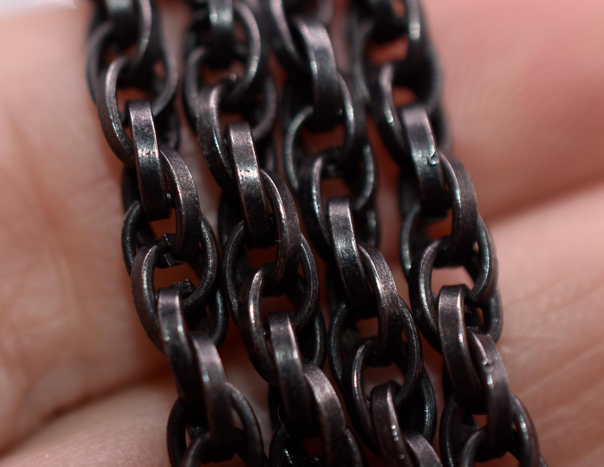 Unusual lightweight original watch chain of gunmetal, a material used to make decorative chains, purses, brooches, buckles and other items during the Victorian era. Gunmetal is an alloy of copper and tin. The chain has interwoven horizontal knot
