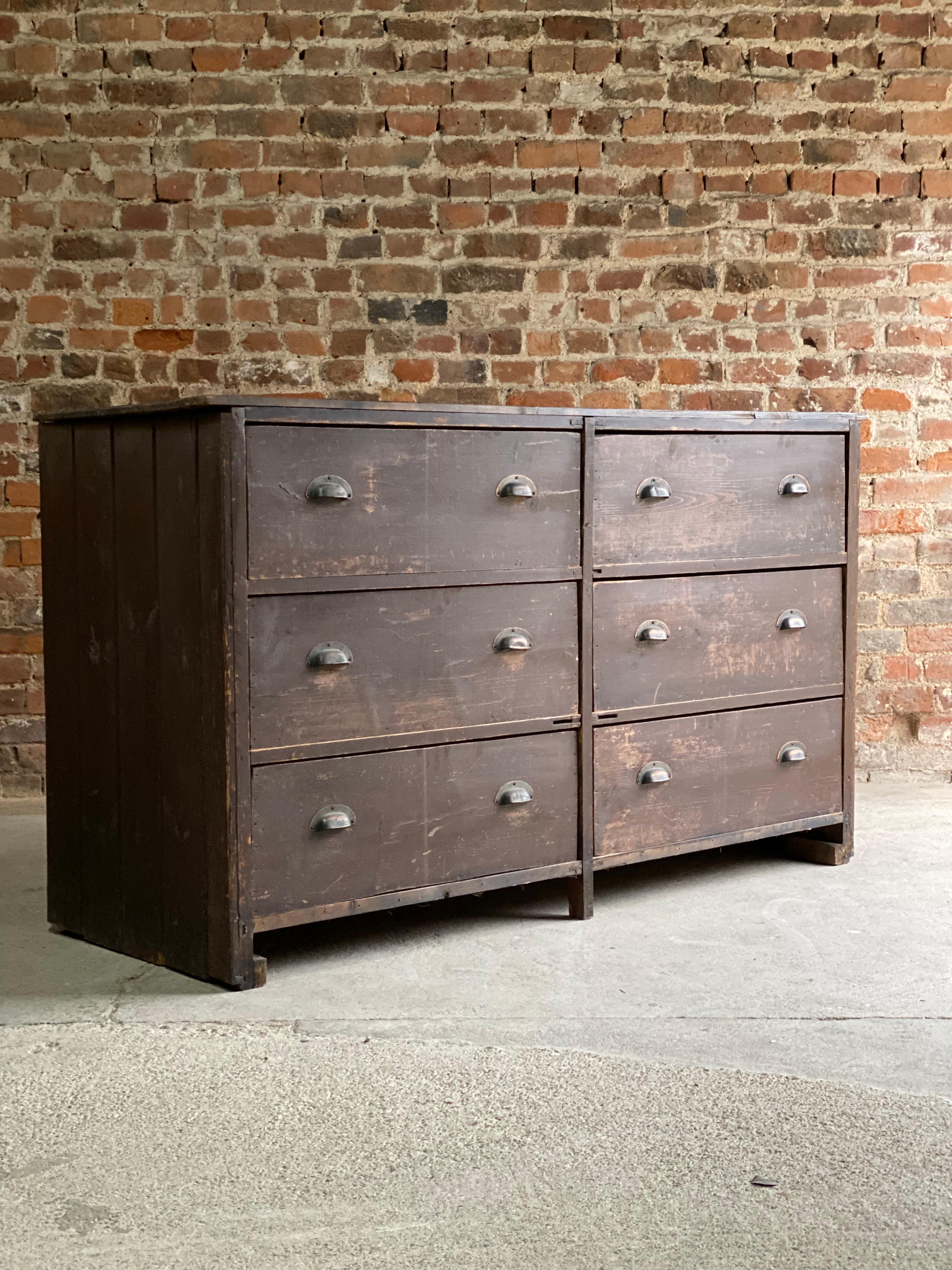 Large industrial haberdashery pine bank of drawers, circa 1890, the rectangular tongue and groove top over six large pull out drawers with original copper cup handles, original rustic appearance with great patina, perfect for that loft space or