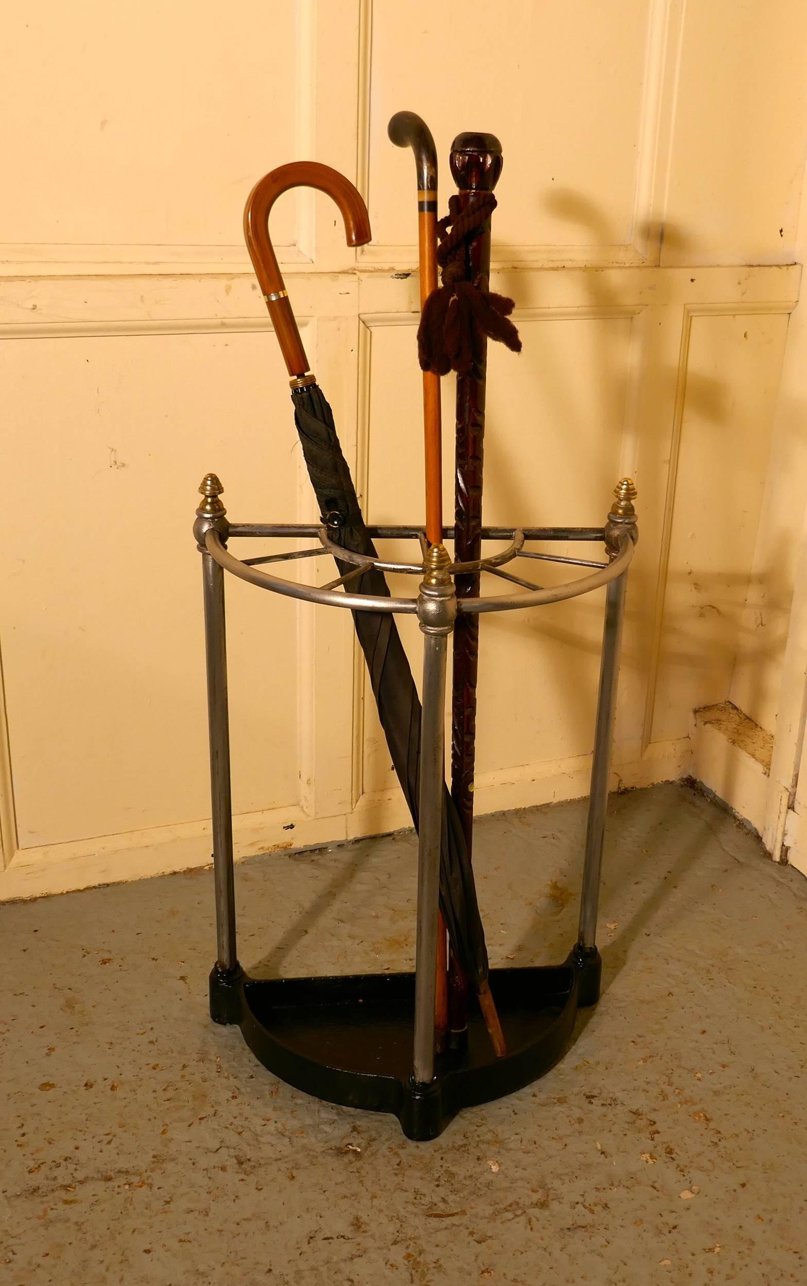 Victorian half round steel & iron stick stand or umbrella stand

A charming piece, and it has a very unusual half moon shape, the steel stand is divided into 5 sections to hold either Walking Sticks or Umbrellas and topped of with brass knobs, the