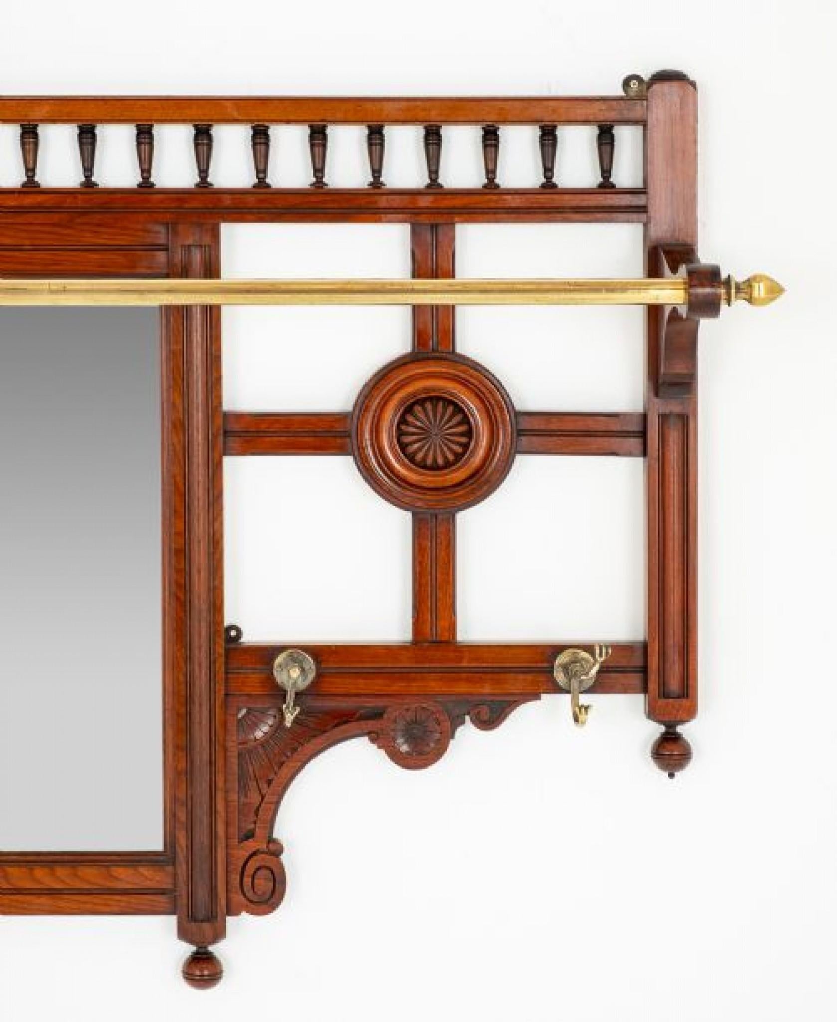 Victorian Mahogany Hall tree.
This Hall Tree Features a Central Mirror Flanked by Turned inset Roundels.
The Top of the Mirror Being of a Galleried Form.
This Tree Comes Complete with Brass Hanging Hooks and Brass Hanging Rail.