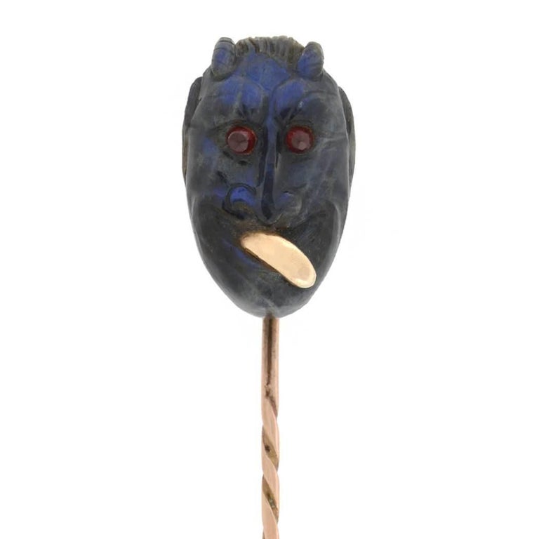 A fabulous labradorite stick pin from the Victorian (ca1880) era! This unique piece consists of a labradorite devil's head at the top of a 15kt rose gold stick pin. The 3-dimensional carving displays incredible facial features, including two pointed