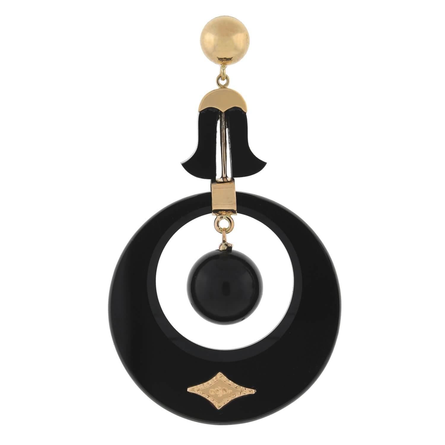 A fabulous pair of carved onyx earrings from the Victorian (ca1880) era! Crafted in 14kt rosy yellow gold, each earring features a stunning front facing carved onyx hoop which dangles a large onyx bead at the center. The polished onyx reflects the