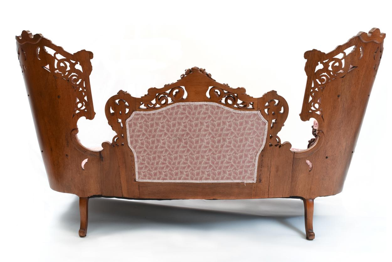 Victorian hand carved and well-proportioned mahogany rosewood Baudoine sofa with center north wind face and pierced carved back and side deign details rested on carved skirt and cabriole legs. The Sofa is in excellent antique condition. Minor wear