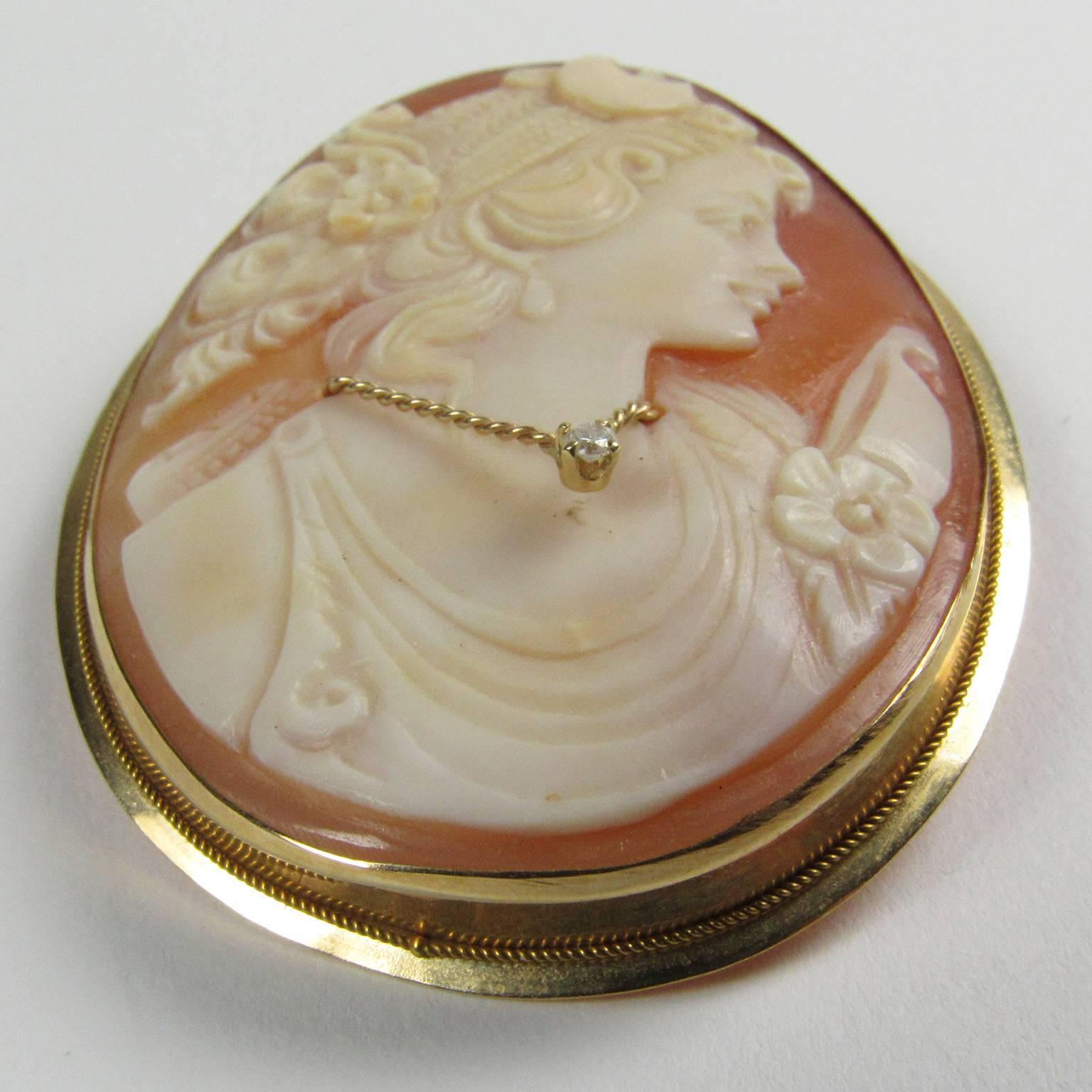 Victorian Hand Carved Shell and Diamond Convertable Cameo Brooch depicting a young woman in profile with a small diamond pendant.  Mounted in a 14kt yellow gold setting, signature on verso is illegible.  Can be worn as a pin or a pendant.  1 7/8 x 1
