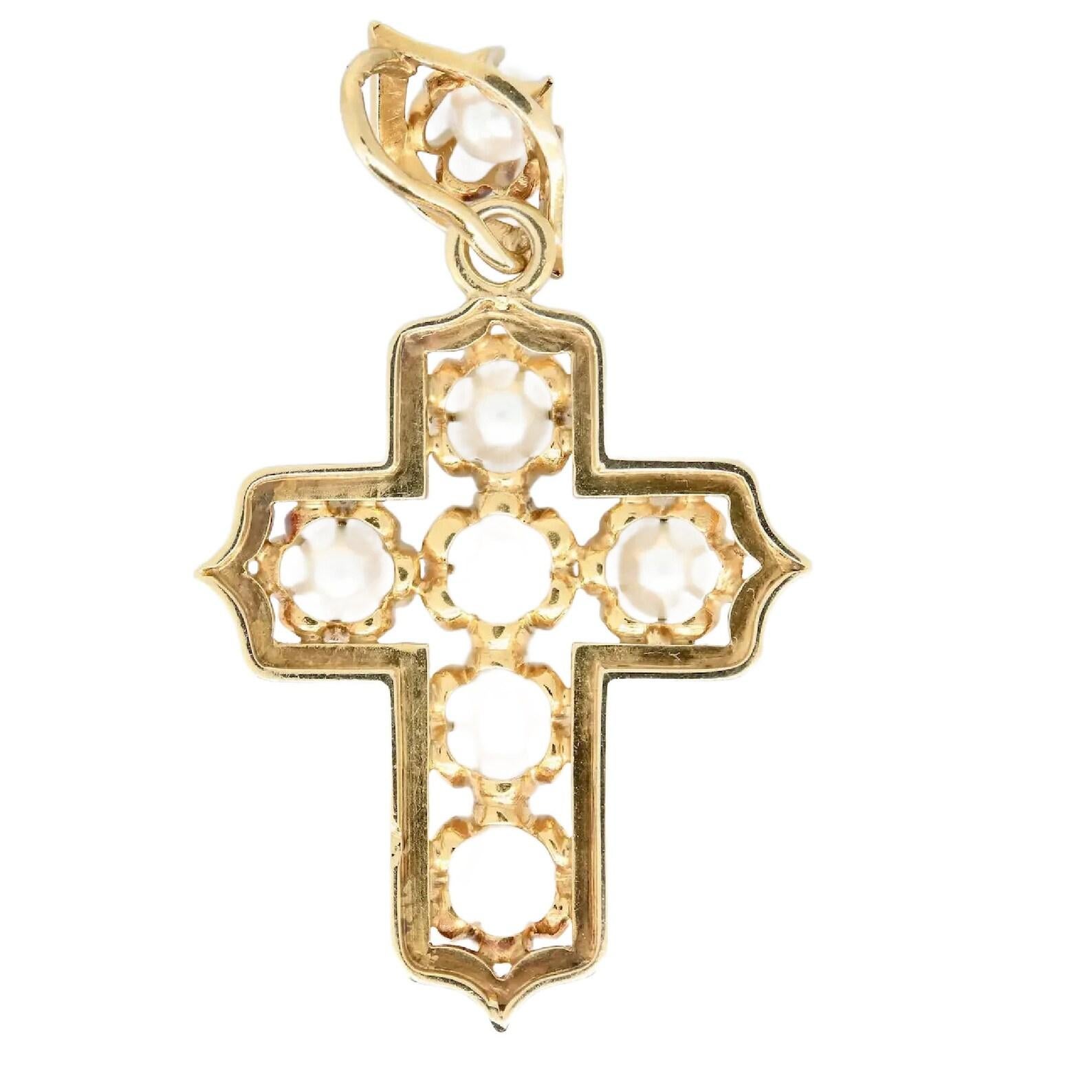 A victorian period hand engraved cross set with seven round white pearls.

Comprised of a pearl set naiveté shaped pendant bale from which suspends an open work cross set with six pearls.

Tested as 18 Karat gold.

Measurements: 2