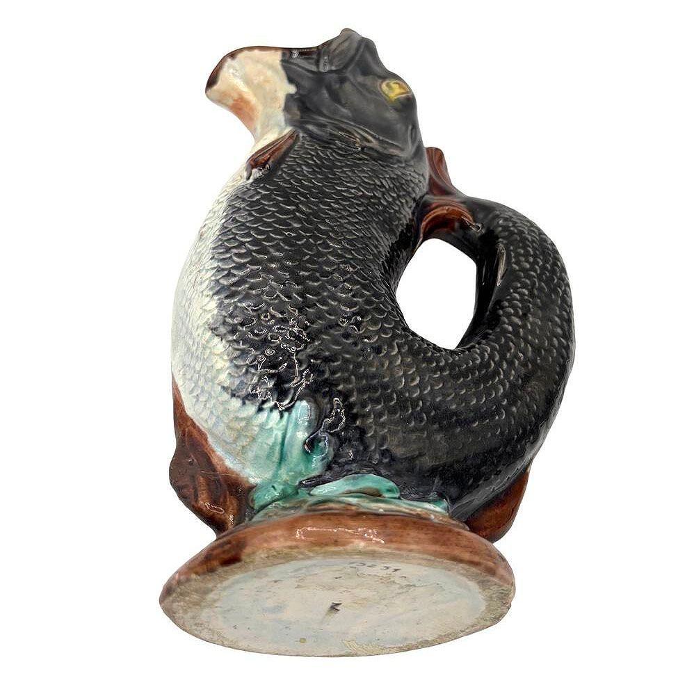 Esta jarra de cerámica de majolica inglesa de finales del siglo XIX es un asombroso ejemplo de la artesanía inglesa de finales de la época victoriana. El vibrante esmalte resalta los intrincados detalles de las escamas y aletas de la trucha, dando