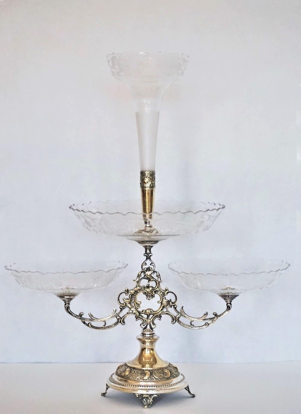 A large fine Victorian silver plate and handcut crystal epergne centrepiece with two branch supporting two crystal bowls and one large crystal bowl to top supporting a central crystal trumpet vase, all with elegant handcut floral designs, England,