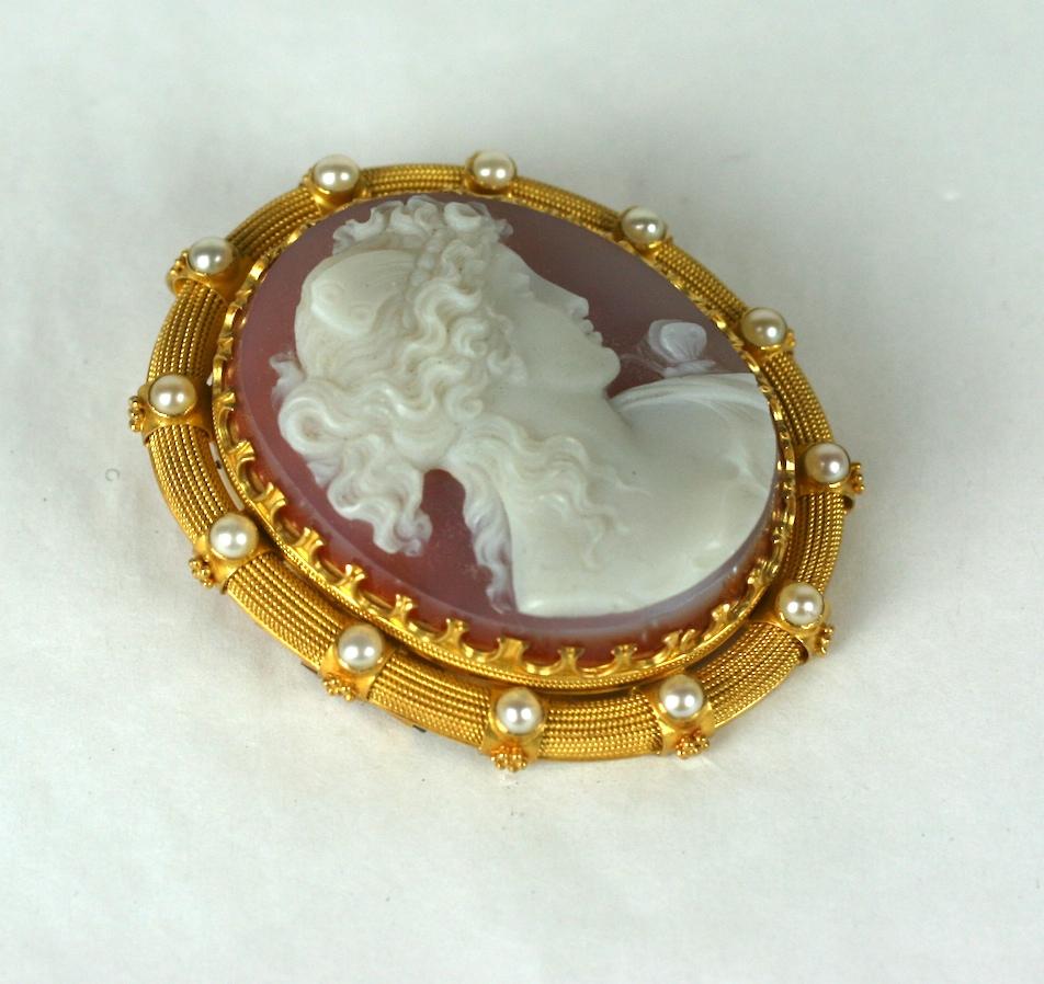 Exquisite Victorian hard stone cameo of the goddess Psyche. 
Beautiful high relief carving with wings in hair and small butterfly delicately perched on shoulder. 
Elegantly mounted in 14-15k gold crown setting within a high carat matte gold border