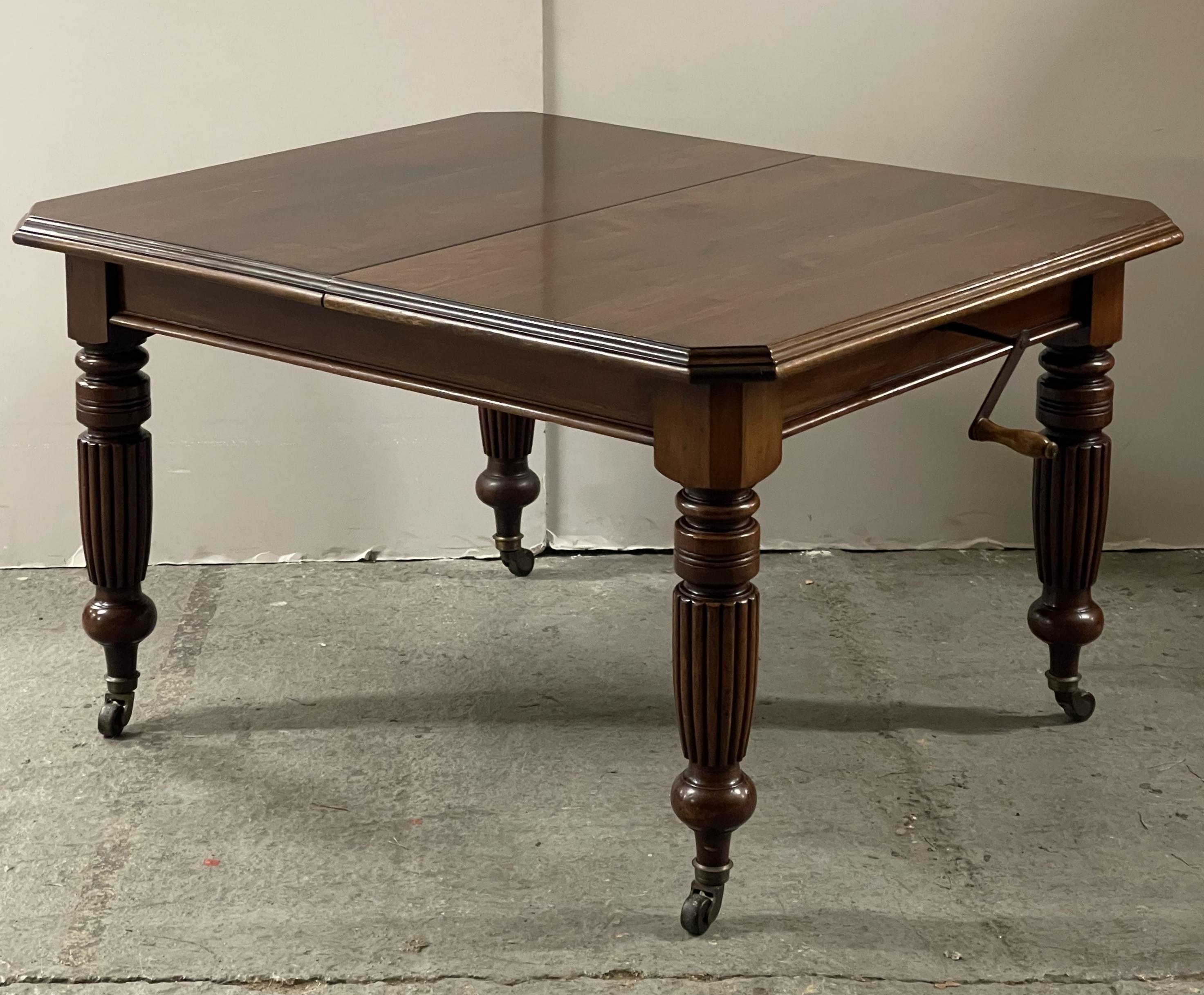 Here we have for sale this stunning Victorian mahogany wind-out extending dining table with canted corners, two additional leaves standing on fluted legs, and ceramic casters.

Overall, this table is in very good condition, it has been cleaned and