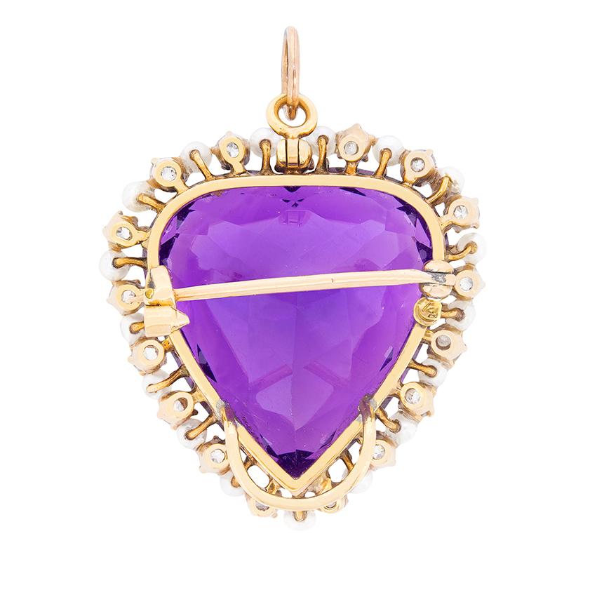 This large brooch pendant is made from a 44.00 carat deep purple amethyst which is natural. It has been expertly cut into shape and is beautifully haloed by a mix of diamonds and pearls. The diamonds which are old cuts, have combined weight of 1.70