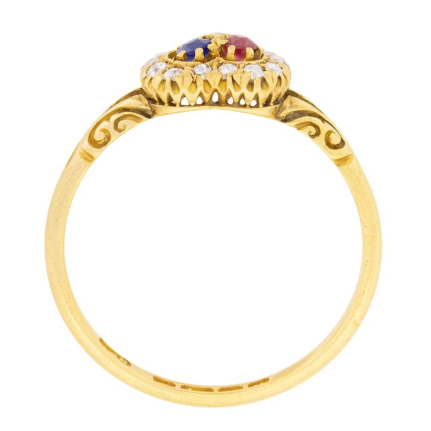Hallmarked in 1902, thia Victorian ring features a diamond, sapphire and ruby all set to centre. The sapphire and ruby each weigh 0.10 carat, whilst the centre diamond weighs 0.03 carat. In the heart shape halo, there are a further 15 diamonds which