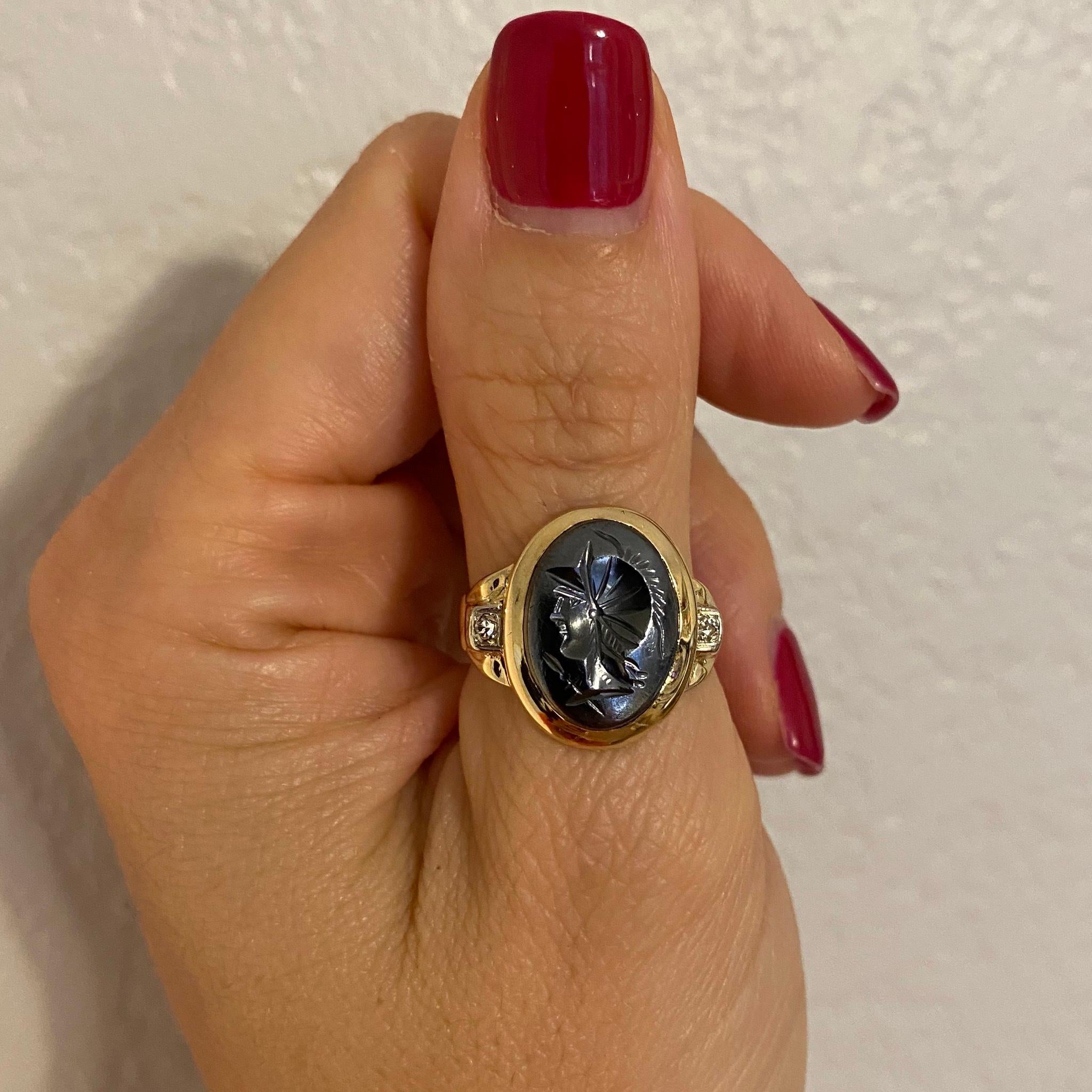 Elegant and handsome Antique Victorian Oval Hematite Intaglio Unisex Signet Ring; the Hand carved image depicts a portrait of a handsome man; set in a hand crafted 14K Yellow Gold mounting with a Diamond on either side. Approx. dimensions: 0.83”w x