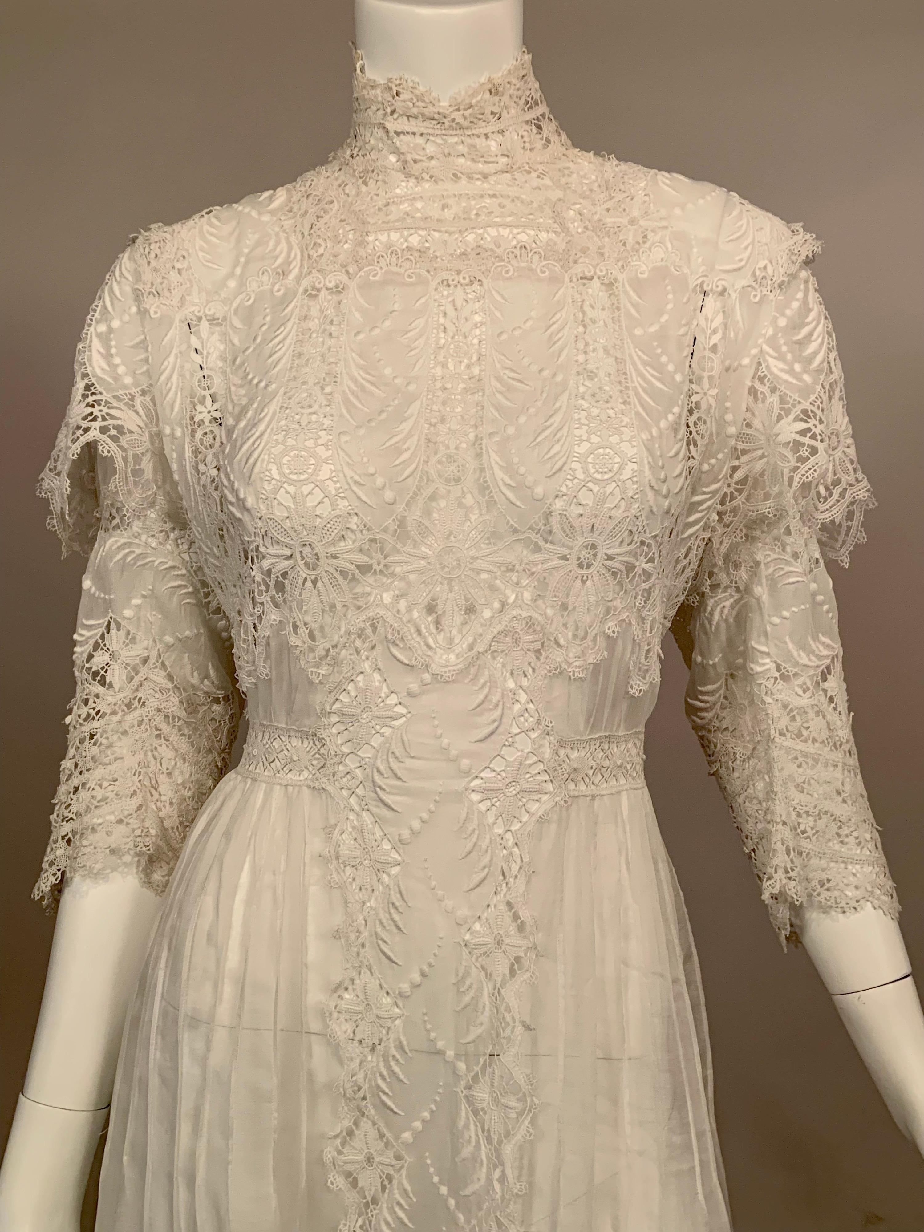 This very rare larger size Victorian white handkerchief linen dress is embellished with both hand and machine made lace. The linen is embroidered on the shoulders, bodice, sleeves and a deep border on the skirt of the dress. The dress has a series