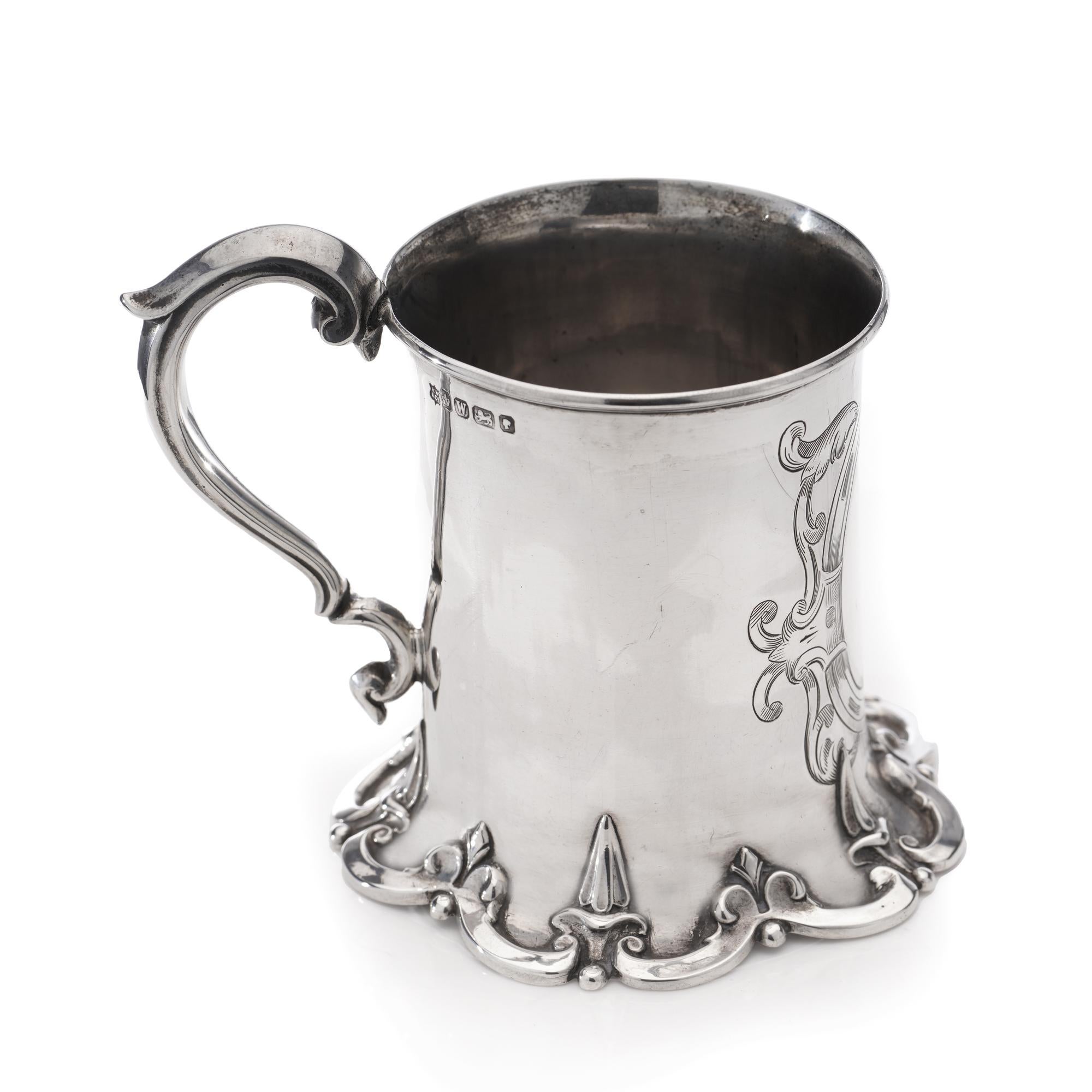 Antique Victorian highly ornate mug with cartouche and scrolls. 
Made in England, Sheffield, 1864
Maker: Henry Wilkinson & Co
Fully hallmarked.

 Approx. Dimensions - 
Length x width x height: 11 x 9 x 9.3 cm
 Weight: 137 grams in total. 

