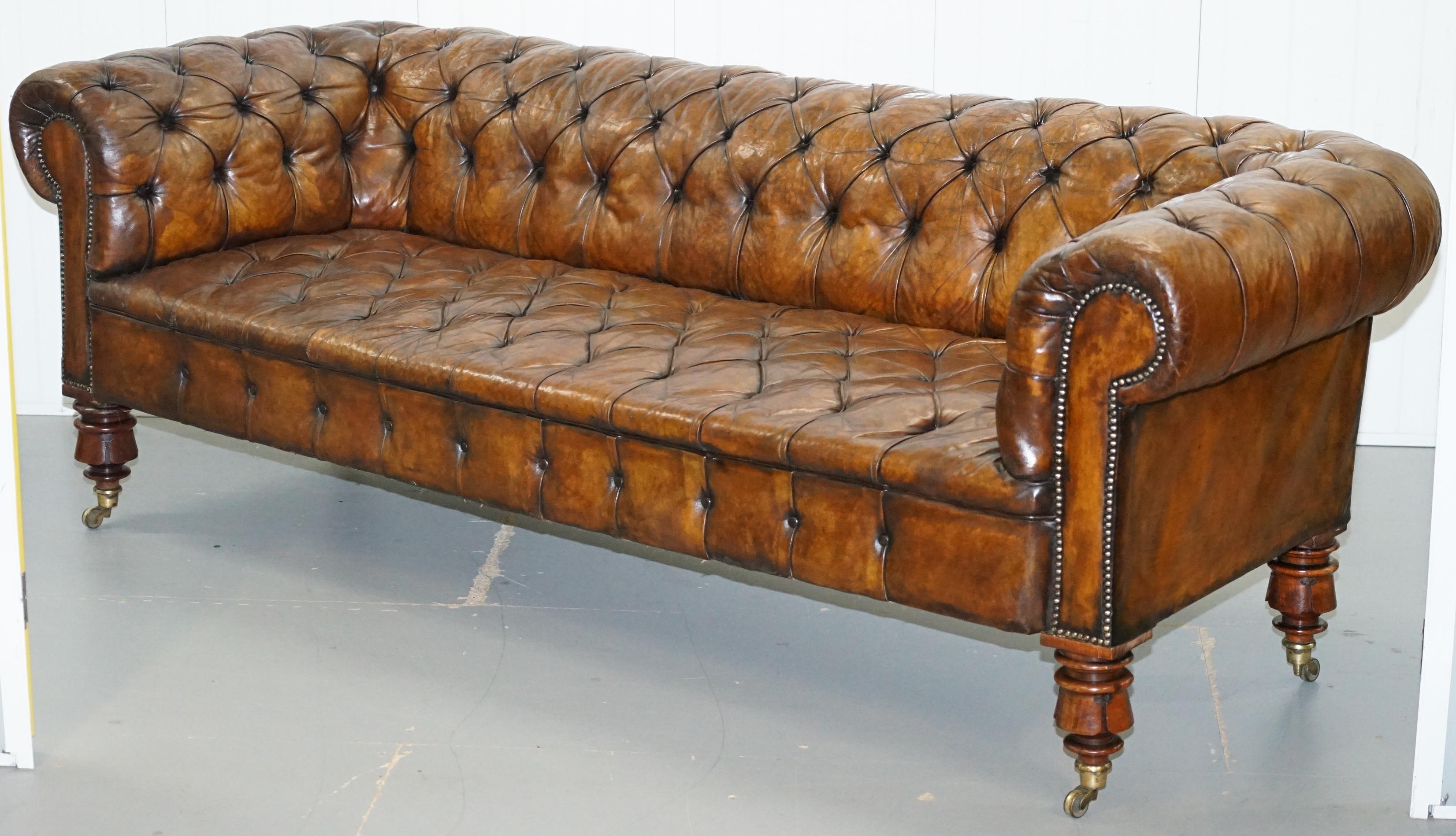 We are delighted to offer for sale this stunning exceptionally rare large original early Victorian tobacco brown leather fully restored Chesterfield buttoned sofa.

This is a very rare model, it has the shorter seat platform but large ornately