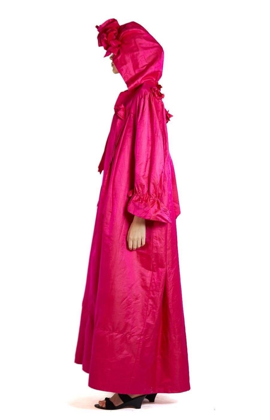 Otherworldly rare and exceptional piece. Sourced in Paris this garment had our jaws dropping when we came upon it. Museum grade in every way.  Victorian Hot Pink Silk & Cotton Sateen Hooded House Dress With Ribbons 