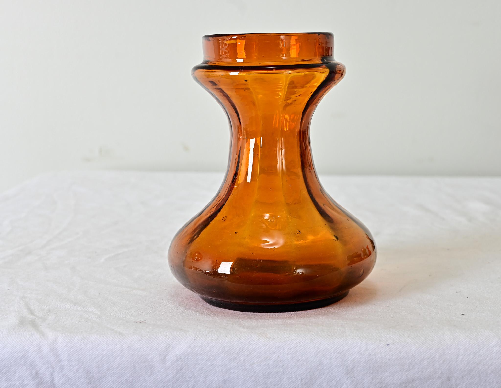 Hand rolled, amber-colored glass hyacinth forcing vase from the 1890’s. View the detailed images.