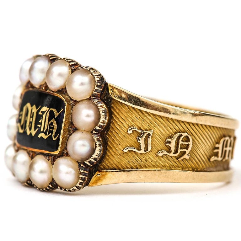 An immaculate Victorian yellow gold enamel mourning ring, the central enamel plaque with the initials for 'MR' (the name of which is 'Margaret K...' sadly the surname has been removed from the inside of the shank) within a natural seed pearl