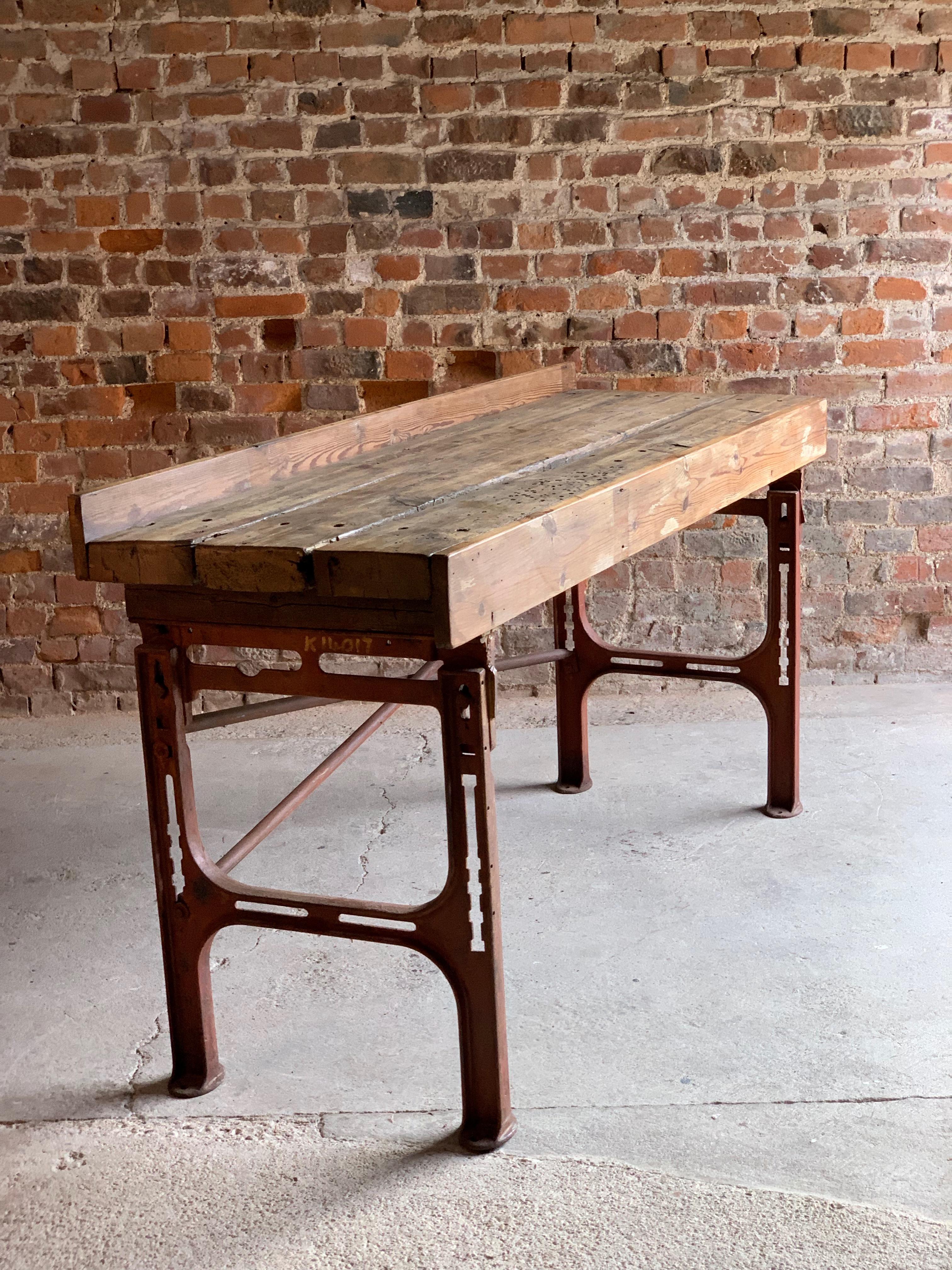 Victorian Industrial workbench table dating to circa 1868

Industrial oak and cast iron workbench table circa 1868, the distressed three plank top over brick coloured cast iron stand with X-frame stretchers, ideal as a console table, media stand