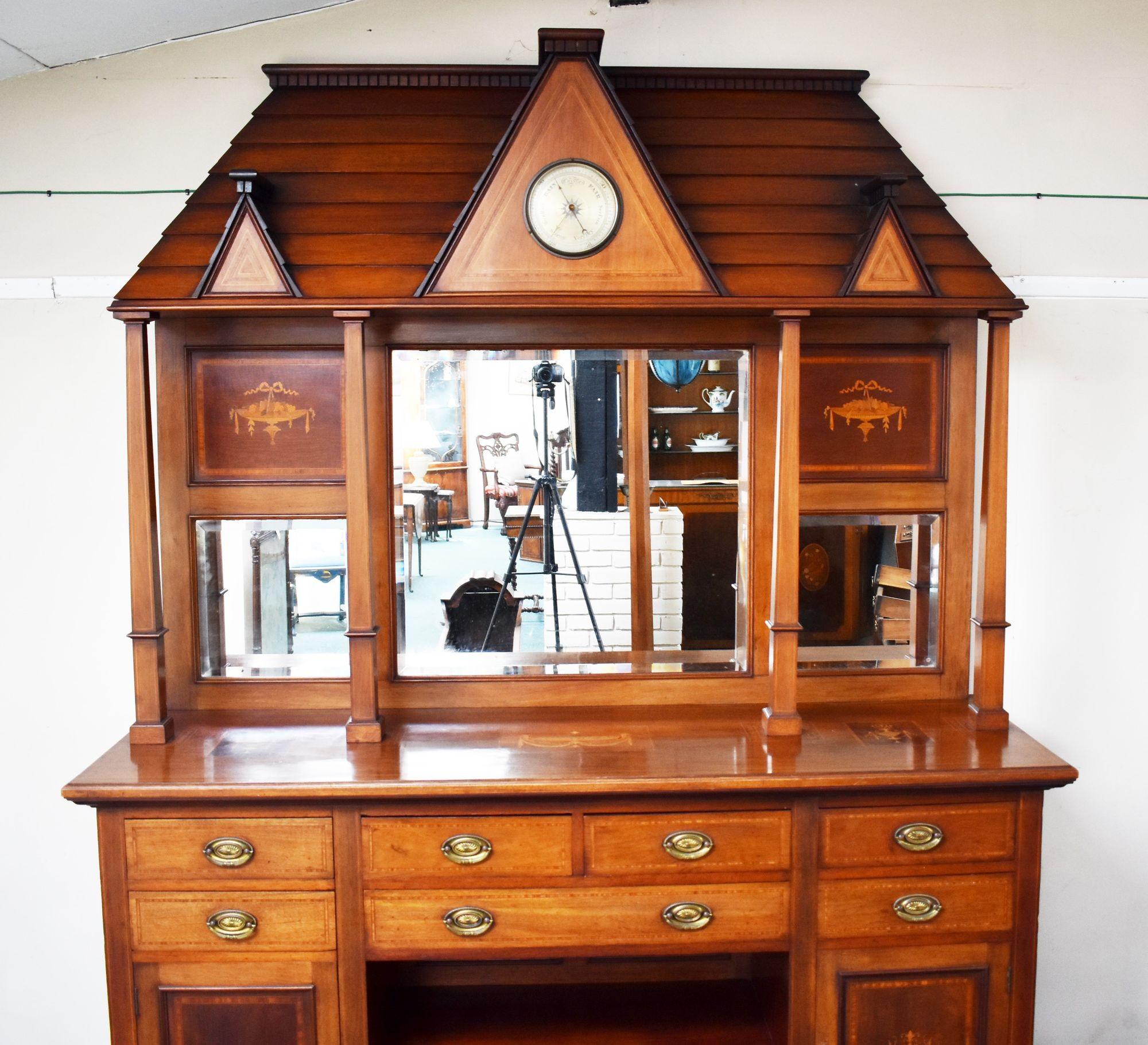 For sale is a good quality, highly unusual, Victorian inlaid walnut mirror back sideboard, the top is of architectural form with a barometer to the centre, supported by tapered columns above the inlaid top. Below this the sideboard has an