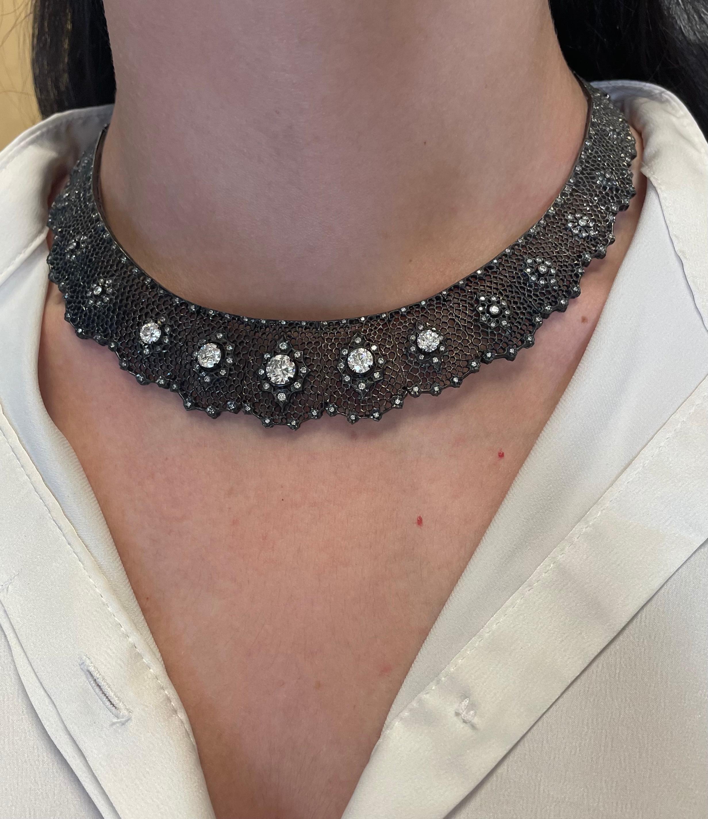 Grand and unique black rhodium finished diamond necklace.
0.94ct center round brilliant diamond, approximately G/H color and SI clarity. 4 round brilliant diamonds, 2.38ct. Approximately G/H color and SI clarity. Complimented by 2.75ct round