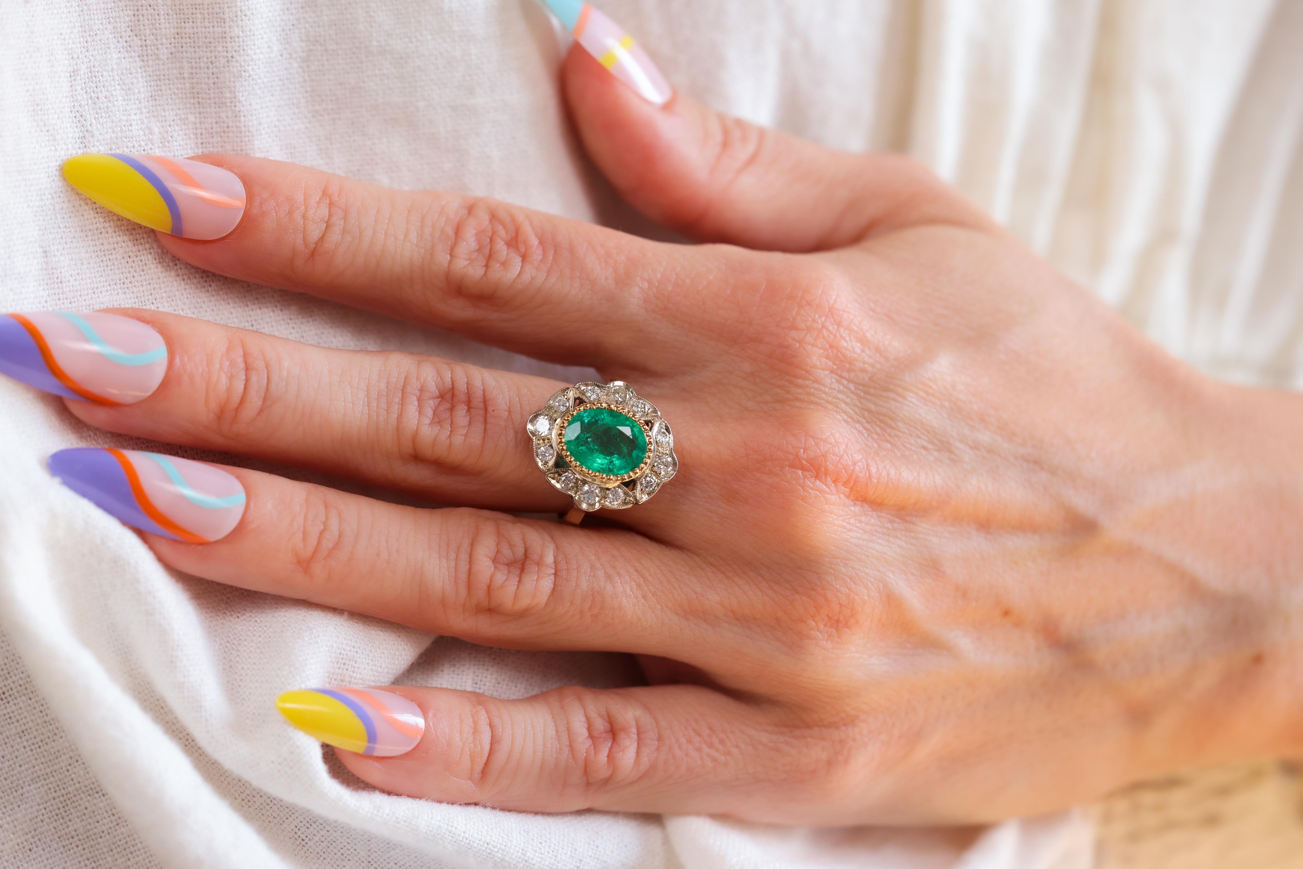 Certificate: GIA
Center Stone: Emerald
Cut: Oval
Weight: Approximately 2.20 Carats
Origin: Ethiopia 
Clarity: F3
Accent Stone: 12 Diamonds
Cut: Round Brilliant 
Weight: Approximately 0.50 Carats 
Color: I-J
Clarity: SI
Metal: 18k Yellow Gold and 10k