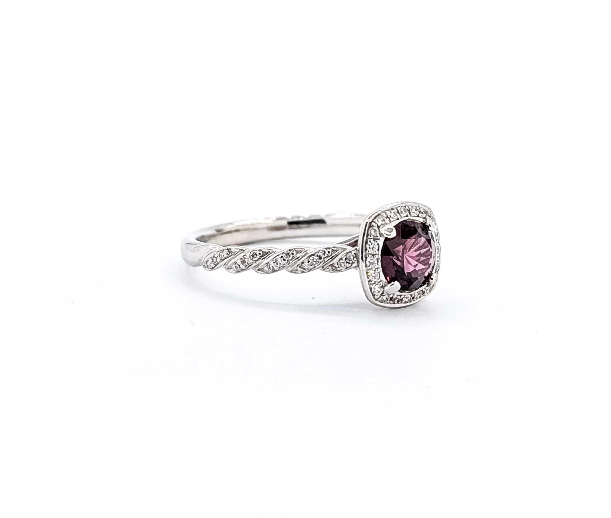 Introducing this beautiful spinel ring crafted in 14k white gold with a braided design. This exquisite ring features a captivating .97-carat raspberry spinel at its center, surrounded by a delicate arrangement of .22-carat diamonds. The diamonds are