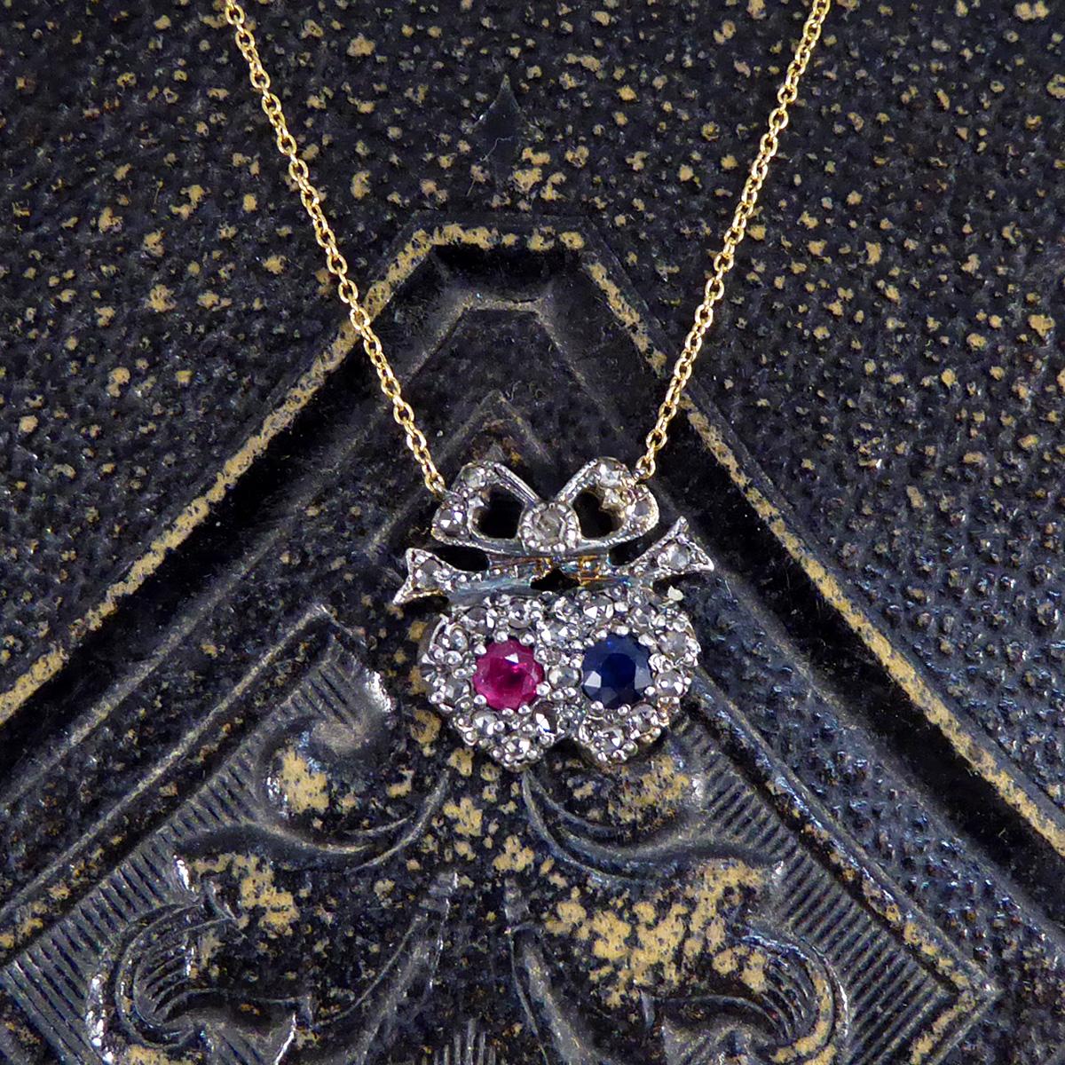 Such a beautifully designed double heart cluster necklace inspired by a classic Victorian piece of jewellery. Featuring in this necklace is a single Ruby and single Sapphire weighing 0.25ct each and surrounded by a cluster of Rose Cut Diamonds in